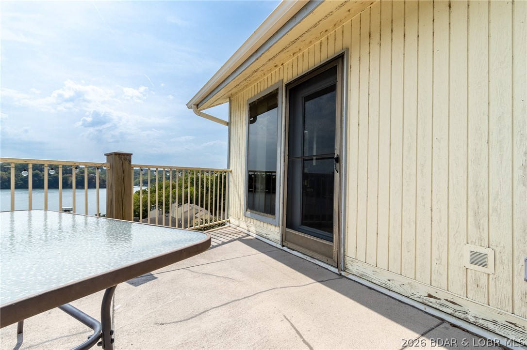 Welcome warm weather and boating season in style at this beautifully appointed lakefront condo in Camdenton, MO, perfectly situated at Mile Marker 9 on the Big Niangua arm of Lake of the Ozarks. As the days get longer and the water calls your name, this top-floor 3-bedroom, 3-bath retreat offers the ultimate launch point for summer on the lake. The second-level loft serves as a non-conforming third bedroom—ideal for hosting family and friends all season long. Spend your afternoons cruising, tubing, fishing, or swimming from your included 10x24 boat slip—just steps away. Included with the condo is your private garage for extra storage.  Well-maintained community dock featuring a fish cleaning station and swim platform make lake days effortless and enjoyable.
From breezy summer evenings to unforgettable sunset views shimmering across the water, this condo captures the very best of lakeside living. Whether you're searching for a full-time residence, a weekend escape, or an investment property with a proven long-term rental history, this opportunity checks every box. Plus, enjoy peace of mind with a brand-new roof recently added to the building. Call for a showing today!