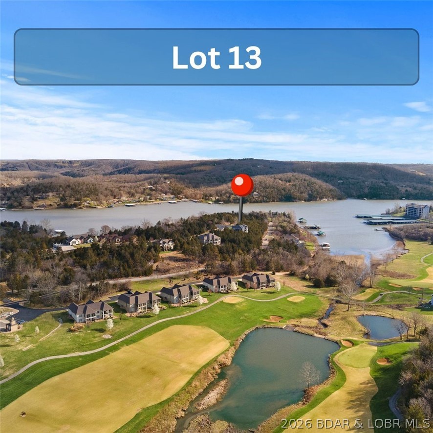 Lot 13 is primed and ready for your dream home in the heart of Old Kinderhook Golf Resort. This homesite holds the perfect blend of scenic lake views and resort-style living. Owners enjoy access to an impressive lineup of amenities including pools, newly updated tennis courts, a workout facility, a seasonal ice rink, sand volleyball court, a café, and an on-site fine dining restaurant. Old Kinderhook offers both on and off the water recreation year round. The time to build is now as the demand for quality new construction at the Lake continues to grow. Secure your forever home or next investment in one of the Lake of the Ozarks’ most desirable golf resort communities and start planning your build today.