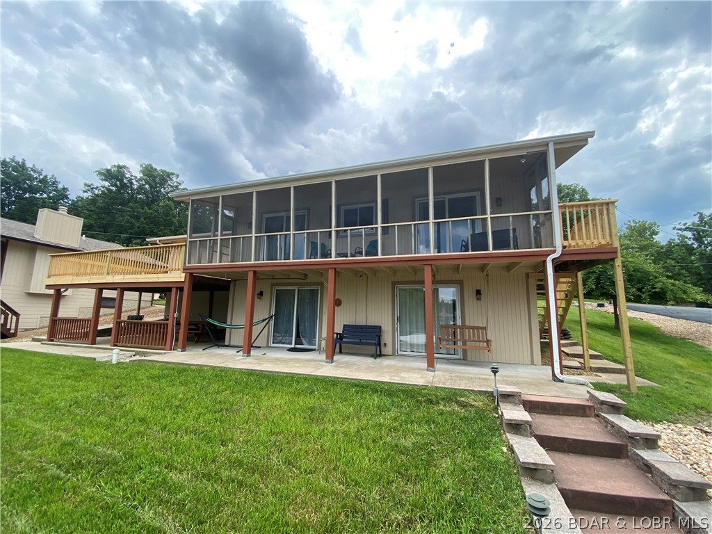 Big price improvement on this turn-key Osage Beach lakefront opportunity with the hard-to-find gentle access buyers are always searching for. Tucked into a protected cove at the 23 MM with only 14 steps to the private dock and an easy drive to the front door, this furnished 4BR/2BA home is perfectly set up for nightly rental income, summer weekends at the lake, or full-time enjoyment. Spend your days on the water and your evenings taking in sunset views from the expansive deck and patio spaces or relaxing in the screened porch after a long lake day. Major recent improvements include a brand-new engineered septic system plus extensive deck renovations with much of the decking, railings, stairs, and supports recently replaced for added value and peace of mind. Inside features vaulted ceilings, warm wood accents, open main-level living, attached garage, and an inviting layout designed for easy lake living. Conveniently located close to popular waterfront restaurants, shopping, and entertainment by land or water. Opportunities with this combination of gentle access, location, updates, and rental flexibility are becoming increasingly hard to find at $625,000.
