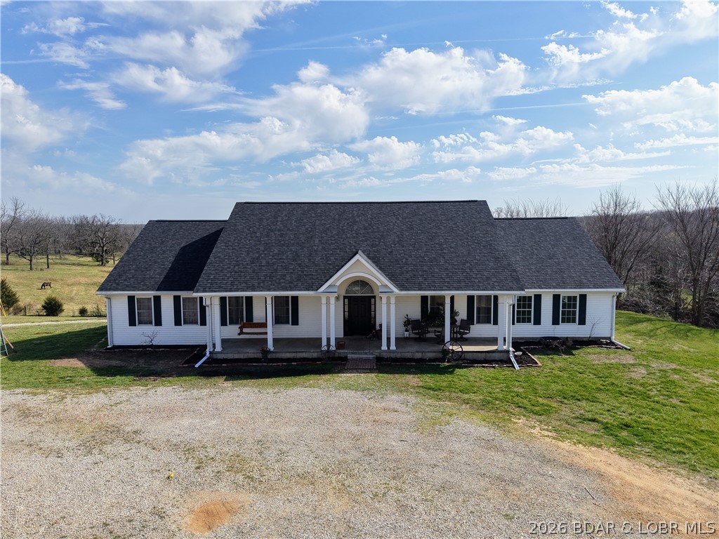 If you’ve been searching for the perfect mix of acreage and a home that truly stands out, this is it. Situated on 40 acres of open and wooded ground, the property offers endless opportunities for farming, recreation, hunting, or simply enjoying the privacy of country living. A pond and shop are already in place, making the land as functional as it is beautiful. Inside, a grand foyer with soaring ceilings and a stunning loft overlook welcomes you in. The open-concept layout flows into a formal dining area and spacious kitchen—perfect for everyday living and entertaining. Just off the living room, a deck overlooks the pond, creating the ideal spot for morning coffee or evening sunsets. A rare indoor pool off the kitchen offers year-round enjoyment. The main level features four bedrooms, including a primary suite with his-and-hers closets and a private washer and dryer hookup. The finished walk-out basement adds a second living area, full kitchen, and two non-conforming bedrooms—perfect for guests or multi-generational living.Recent updates include new flooring (2026), a 2023 roof, and geothermal heating for efficiency and comfort.