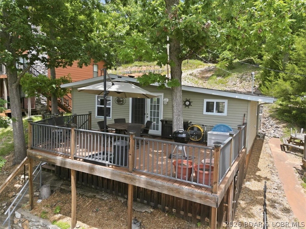 Enjoy the Lake of the Ozarks lifestyle with this charming Rocky Mount retreat! Whether you're looking for a weekend getaway, full-time residence, or investment opportunity, this property offers the perfect combination of relaxation and recreation.

Being sold fully furnished, this move-in ready home features new mattresses in both bedrooms, a new water heater, new water softener, and a large-capacity stacked washer and dryer. Located in a peaceful lakeside community, along with the oversized deck, you'll have easy access to boating, fishing, swimming, and all the amenities the lake has to offer.

A standout feature is the private two-well dock equipped with two 6,000-pound boat lifts, providing convenient and secure storage for your watercraft. The swim platform creates the perfect spot for summer fun, entertaining, or simply enjoying the water. Residents also enjoy access to a community boat ramp!

Spend your mornings enjoying lake views, your afternoons on the water, and your evenings unwinding in the tranquility of this sought-after Rocky Mount location. Don't miss this opportunity to own a turnkey piece of Lake of the Ozarks paradise!