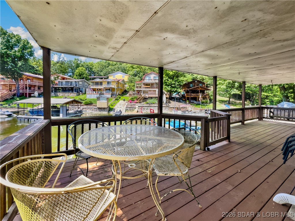This lake home has it all for 1 price - Boat, 2 PWC's, Paddle boat, Kyak, completely furnished all included with this cute 2 bedroom home on Lake of the Ozarks. Day dock with two drive on PWC lifts as well as the wet steps, make it easy to play off of your dock or hop on one of your toys to enjoy the lake and the local restaurants and pubs. House comes completely furnished as you see in the pictures, everything stays, (turn key). Start enjoying your lake lifestyle the very first day. Home has been a place of great enjoyment for years by the current owners. Make your appointment now so you can start enjoying your Lake life style today.