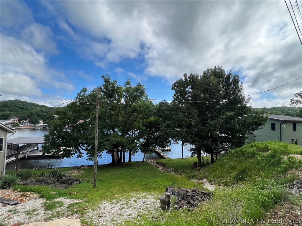 Finding the perfect lakefront lot just got easier! If you've been searching for the ideal place to build your dream lake home, this property checks the boxes buyers struggle to find—great location, excellent topography, protected cove setting, & a price point that makes sense. Offering 85 feet of lakefront w/a generous dock envelope, this homesite provides the opportunity to design the lakefront lifestyle you've been waiting for. The cove location creates a more peaceful setting while still allowing you to enjoy everything Lake of the Ozarks has to offer. The favorable terrain is a huge advantage when building, helping maximize design options & outdoor living potential. Imagine walls of windows overlooking the water, outdoor entertaining spaces, & your custom dock just steps away. Whether you're planning a full-time residence, weekend getaway, or future investment, quality lakefront lots w/this combination of shoreline, usability, location, & value are getting harder to find. Don't settle for a difficult build site when you can start w/a property that already offers the features buyers want most. Bring your builder, your vision, and create the lakefront home you've always wanted.
