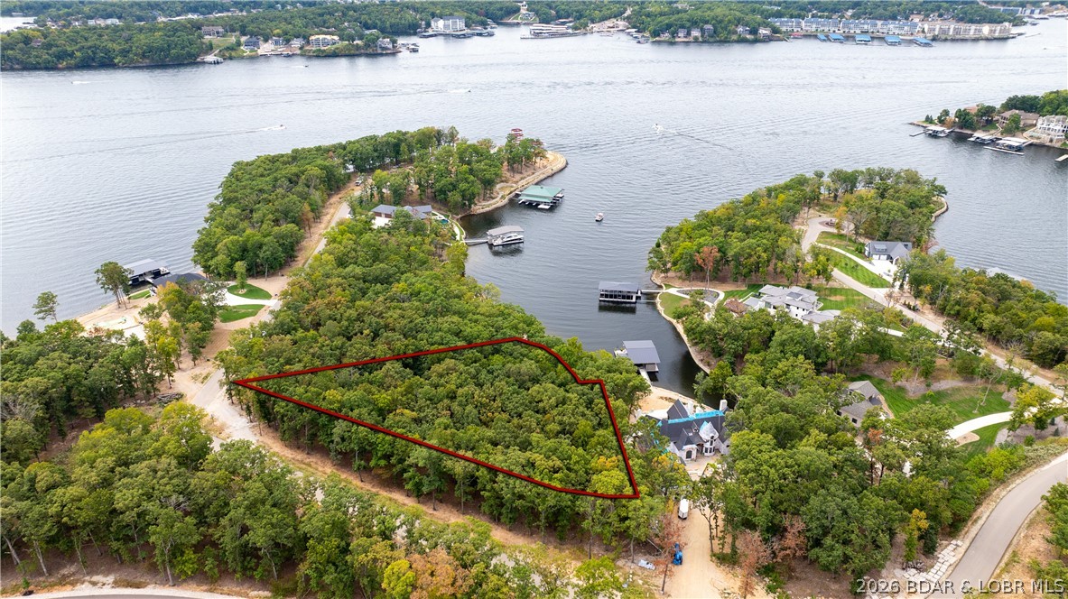 Offering almost 5 acres and 421' of shoreline, this double lot in the most prestigious area of The Villages is the Perfect spot to build your dream home! Unmatched privacy, huge building site along with protected dock envelope, the gentle topography makes this desirable for any style of home. Multi-million dollar homes are being built all around this spectacular setting. Everything you need is just across the community bridge. Only minutes from fun activities on Bagnell Dam, multiple groceries stores, shops, restaurants and medical facilities by land offers convenient living. Hop in the boat and you can be at multiple water entertainment complexes including Dog Days, Redhead Yacht Club, Backwater Jacks and for that fine dining experience check out the Reserve! Combine this with the adjacent lot 457 (MLS 3587264) and you have a place to build your lake masterpiece!