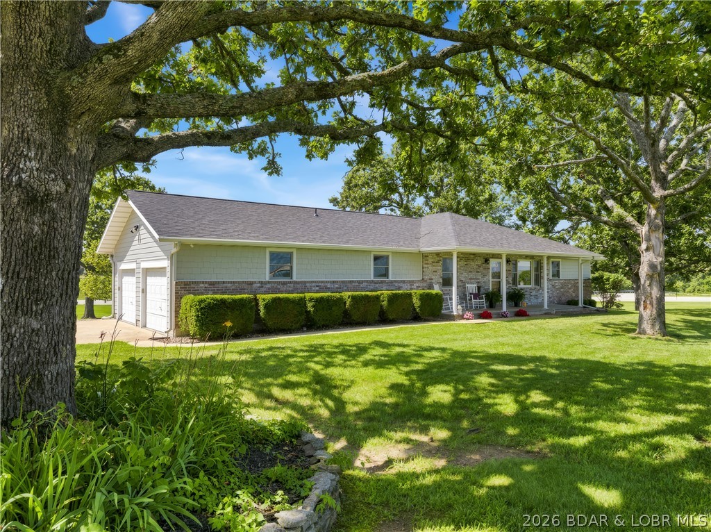 Custom Built and well maintained Home on 2.7 Acres.  There is an inviting covered Front Porch that opens to a large Living Room with Sliders to a new covered Deck.  The home has lots of Wood Flooring.  The open Dining Area leads into an updated Kitchen, Custom built Cabinets with pull-out Drawers and 3 Pantries.  The main floor Master Bedroom/Bath has a Linen Closet and large Walk-In Closet.  Laundry Room is on the main floor with a large Linen Closet.  There is a Family Room downstairs with a Fireplace, Wood Décor Tile Flooring and French Doors going out to a large covered Patio.  The 2nd Master Bedroom/Bath has a Walk-In Shower.  The 4th Bedroom downstairs is nonconforming and also could be used as an Office or Craft room.  There is a 2-Car attached Garage and a large 3-Car detached Garage with workshop area.  Newer engineered LP Smart Siding and newer Roof.  New Garage Doors are being installed.  Lots of nice Landscaping, area for a Garden and blacktop roads.