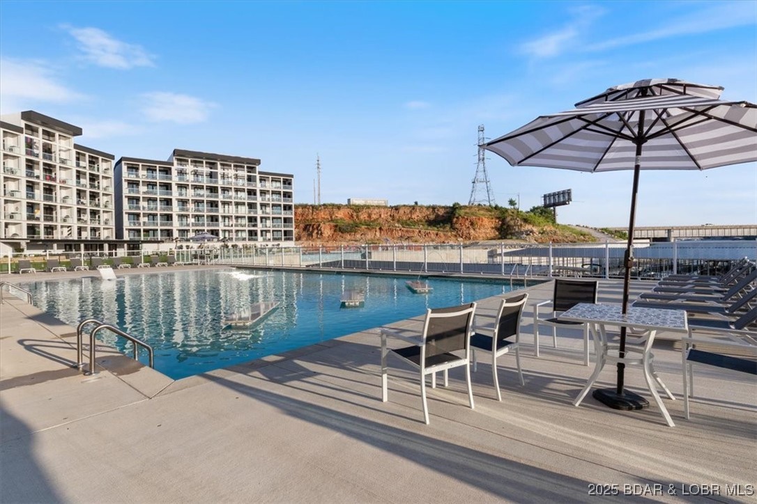 Enjoy panoramic main channel views from this sleek, modern Topsider condo overlooking the Lake of the Ozarks. Watch the annual Shootout boat races and take in direct views of the upcoming Oasis at Lakeport amusement park across the water. Built in 2022, this sleek residence features high-end finishes, an open-concept layout, and designer furnishings throughout. The gourmet kitchen offers quartz countertops, stainless steel appliances, and custom cabinetry, seamlessly flowing into the elegant living area and private balcony. The Topsider complex delivers resort-level amenities, including two large infinity-style pools, an impressive clubhouse, and elevator access for ease and comfort. Whether you’re seeking a personal retreat or a high-end vacation rental, this property offers unmatched luxury, design, and lakefront lifestyle.