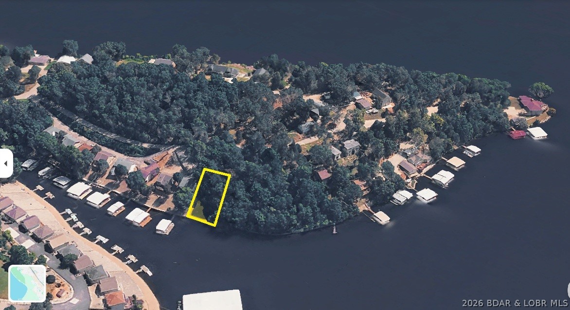 Affordable lakefront opportunity with year-round deep water! Build your dream home on this waterfront lot in a highly desirable Lake of the Ozarks location. The property offers a gentle approach with a more level area toward the back, providing space for outdoor living, entertaining, or a backyard retreat. One of the standout features is the deep-water location, offering excellent water depth for docks and boating throughout the year—even during periods of abnormally lower lake levels. Connection to city water and sewer is available as well. Enjoy beautiful main channel views with cove protection, and convenient access to many of the area’s favorite waterfront restaurants, bars, marinas, and attractions by both land and water. Located just 20 minutes from the Lake Ozark Strip, this property combines peaceful lakefront living with easy access to shopping, dining, and entertainment. Whether you’re looking to build a full-time residence, vacation getaway, or investment property, this affordable waterfront lot offers the ideal setting to enjoy the Lake lifestyle. Don’t miss this chance to own a piece of prime shoreline at an attractive price!