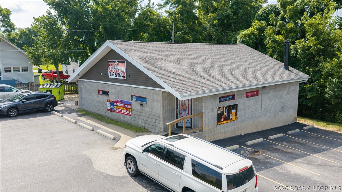 Located in the heart of Camdenton just behind the Camdenton Square, this turnkey opportunity includes both the established Firestation Bar & Grill business and the 1,817 sq ft building it operates from. Positioned in a central, high-visibility location with easy access, the property is currently functioning as a successful restaurant/bar and is fully equipped for its next owner to step in and operate immediately. The building features two restrooms, a fully outfitted kitchen with all appliances included, a newer freezer addition for expanded storage capacity, and all tables and chairs conveying with the sale. The layout offers a welcoming dining and bar atmosphere with flexibility for continued restaurant use or future business concepts. Whether you’re an investor or an owner-operator looking to expand, this is a rare opportunity to purchase both the real estate and the business in one package.