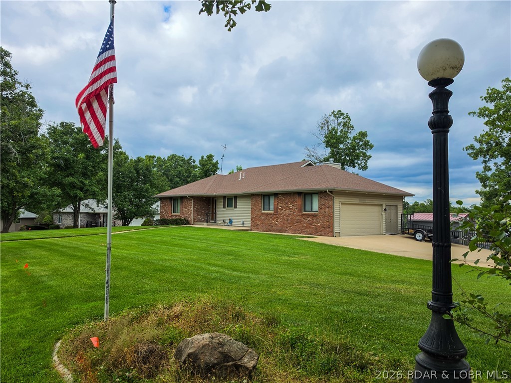 Pride of ownership is evident throughout this updated, 3-bed, 3-bath home overlooking the golf course. Designed to make the most of its peaceful setting, the home offers beautiful views from nearly every angle. Start your morning with coffee on the new screened-in deck, relax on the covered patio below or simply enjoy the scenery through the large windows filling the home with natural light. The open kitchen has an eat-in bar & flows into the dining & living areas where the fireplace creates a warm gathering space for cooler Missouri evenings. The spacious primary suite includes a walk-in closet, walk-in shower & private deck access—perfect for tranquil mornings or relaxing at the end of the day. A large bonus/recreation room offers flexible space for entertaining, hobbies, guests, or a home office. The attached garage, detached storage shed, and lower-level storage room provide plenty of space for vehicles, a golf cart & outdoor equipment. Located in a welcoming golf course community with an on-site restaurant, this beautiful property is ready for any family & an ideal option for anyone ready to move off the lake while staying close to everything they love about the area.