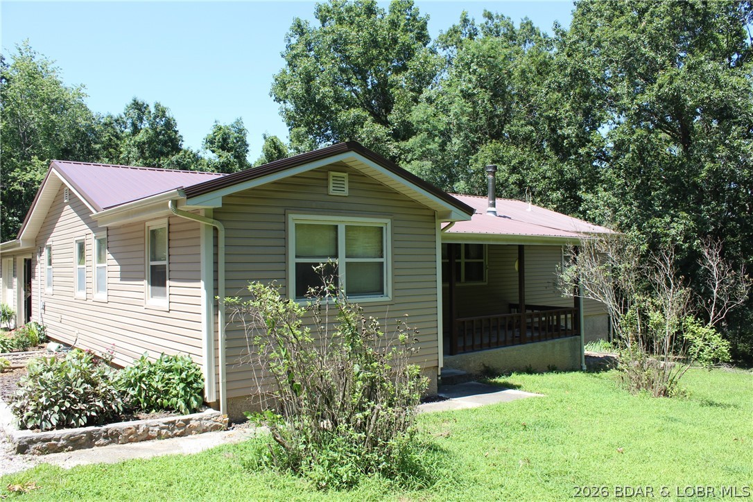 Enjoy the privacy of 31.78 mostly fenced acres just off P Road in Gravois Mills, offering peaceful country living just minutes from Lake of the Ozarks. This 2,247 sq. ft., 3-bedroom, 2-bath home features a spacious primary suite with a walk-in shower and walk-in tub, a covered front porch, large back deck, attached 2-car garage, and a large storage shed. The deck previously surrounded an above-ground pool and offers plenty of space for entertaining or a future pool setup.

The acreage includes established trails throughout the property, multiple deer stands, a wet-weather creek, a fenced garden area, and abundant wildlife, making it ideal for hunting, recreation, or simply enjoying your own private retreat.

Recent improvements include new siding and a new roof within the last 2–3 years, providing added peace of mind. Whether you're looking for a full-time residence, hunting property, or weekend getaway, this property offers the space, privacy, and convenience that's hard to find.