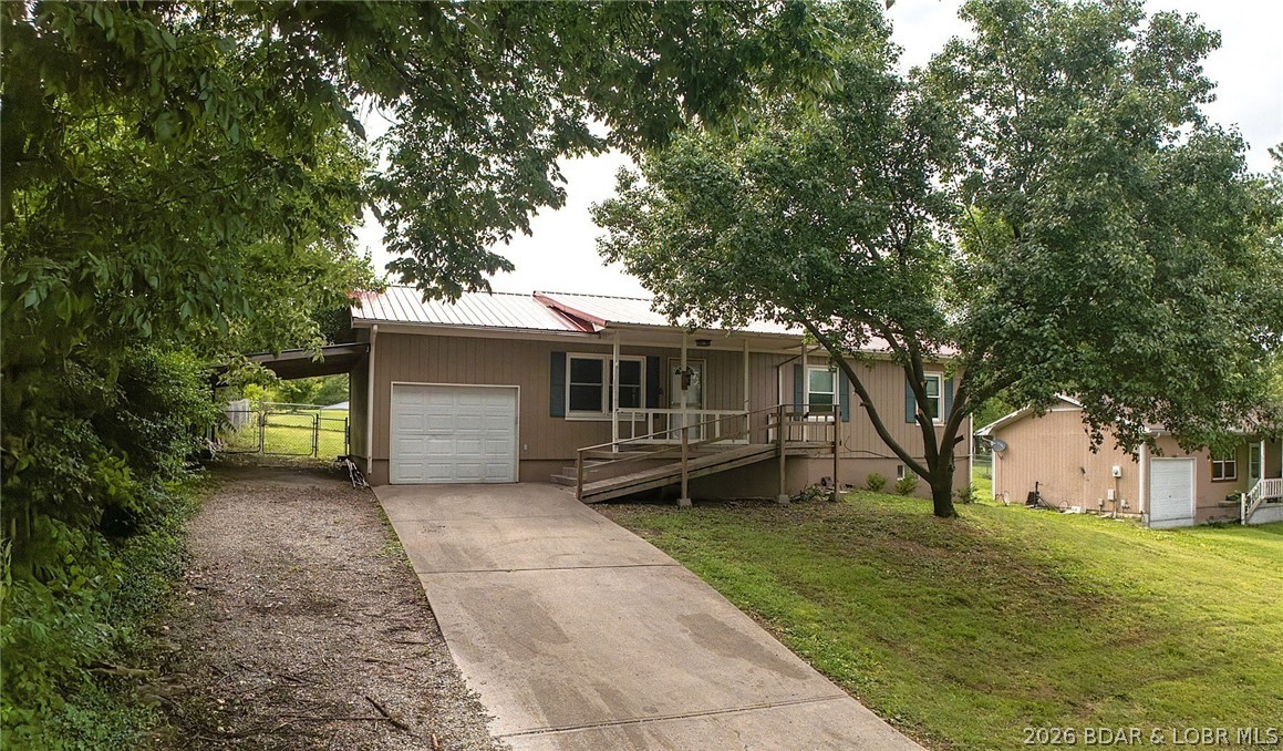 4-bed, 2-bath home in Warsaw featuring an open floor plan, hardwood floors and nice-sized bedrooms. The spacious kitchen offers granite countertops and plenty of cabinet space, while the durable metal roof adds long-lasting value. Downstairs you'll find a large bedroom, a full bathroom, utility room, a safe room for your peace of mind, and ready to personize flex space easily customized fora home office, workout area, or creative studio! Step outside to a large, fully fenced backyard complete with a charming pergola perfect for relaxing evenings, gatherings, or pets and kids at play. Conveniently located close to Truman Lake, Lake of the Ozarks access, Drake Harbor, this property has so much to offer!