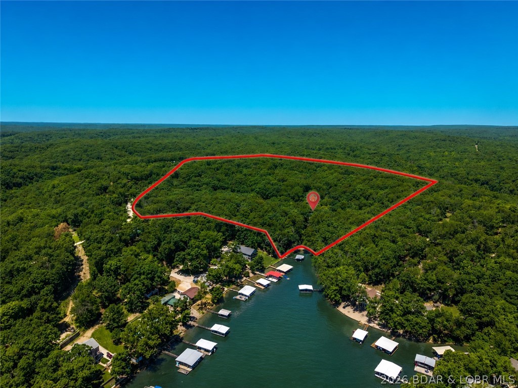 Rarely does a property come along that offers this combination of acreage, lakefront, privacy, and living space. Situated on approximately 24 gentle acres, this impressive 6-bedroom, 3.5-bath lakefront home creates the ideal setting for those seeking a private retreat, family compound, or estate-style property at Lake of the Ozarks. With ample room to spread out, the home offers multiple gathering spaces for entertaining, holidays, and making lifelong memories. Outside, the gentle acreage provides endless possibilities for recreation, additional improvements, or simply enjoying the peace and privacy that are becoming increasingly difficult to find. Adding even more value, the large detached garage/shop provides storage for vehicles, boats, equipment, and lake toys. Major capital improvements have already been completed, including brand-new roofs and gutters on both the home and shop, along with a newer septic system, giving the next owner confidence that many of the big-ticket expenses have already been addressed.
Whether you're searching for a secluded full-time residence, a family getaway, or a unique lakefront estate property, opportunities like this are few and far between.