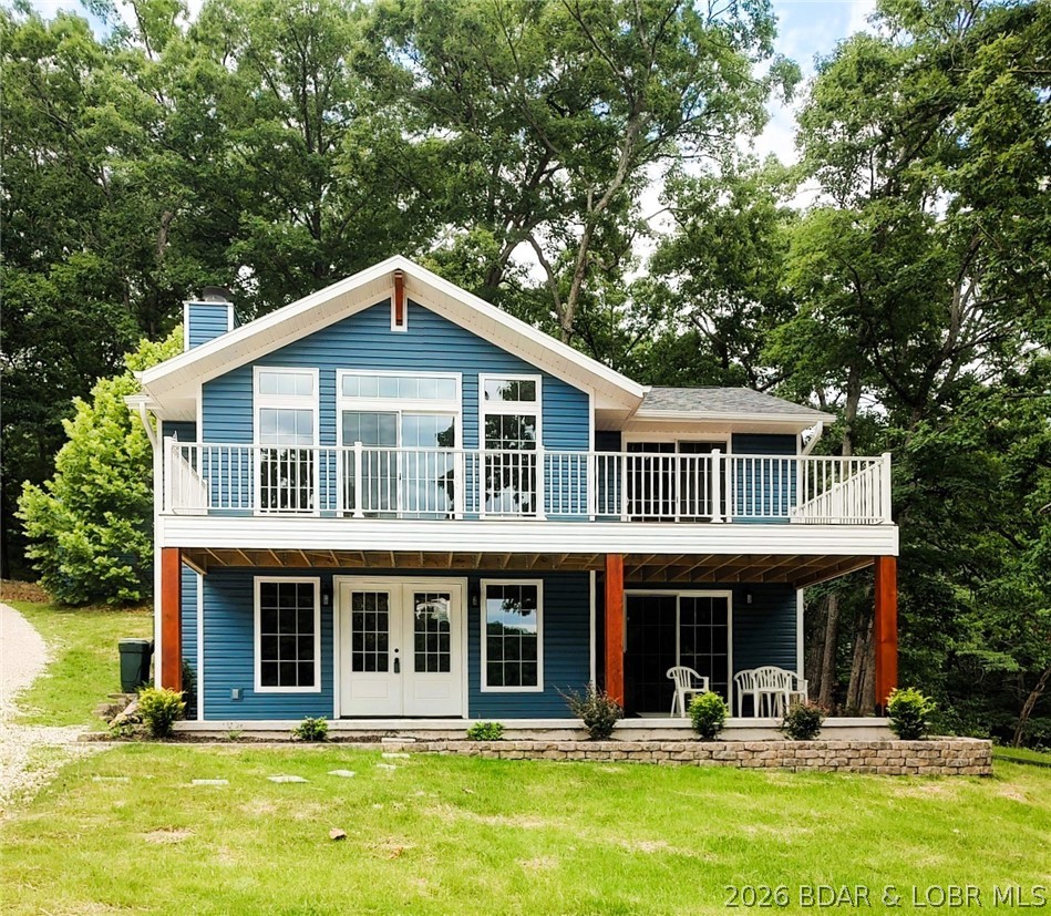 Beautiful lakefront home feels like brand new. Recently rebuilt top to bottom delivers quality craftsmanship inside & out. All the work has been done & ready to move in. Step inside the well designed floor plan for lakeviews & high end details. Open main level living room spans the entire front of home with wall of windows & fireplace . Spacious kitchen, upgraded cabinetry, granite counters, bar, SS appliances & laundry room. Staircase opens up to vaulted ceiling familyroom, Main bedroom suite, 2nd bedroom & half bath. Exterior door to back yard deck. One nonconforming BR for guest or office. Sun filtering through the trees makes it easy to find wood for the fireplace. Green grass & landscaping gives an easy stroll, no stairs to 2 well boat dock.Level lakefront & sandy beach is hard to beat & find at the lake making this property dog & kid friendly. 100 ft +/- at waters edge just over a half acre & water depth for all the seasons. 20 x 18 metal garage/shop electric & shed for storage. End of road with parking for family & friends privacy & space in a cove protected with main channel view. Home faces east to enjoy sunrise.