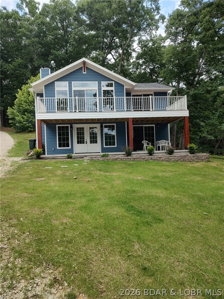 Beautiful lakefront home feels like brand new. Recently rebuilt top to bottom delivers quality craftsmanship inside & out. All the work has been done & ready to move in. Step inside the well designed floor plan for lakeviews & high end details. Open main level living room spans the entire front of home with wall of windows & fireplace . Spacious kitchen, upgraded cabinetry, granite counters, bar, SS appliances & laundry room. Staircase opens up to vaulted ceiling familyroom, Main bedroom suite, 2nd bedroom & half bath. Exterior door to back yard deck. One nonconforming BR for guest or office. Sun filtering through the trees makes it easy to find wood for the fireplace. Green grass & landscaping gives an easy stroll, no stairs to 2 well boat dock.Level lakefront & sandy beach is hard to beat & find at the lake making this property dog & kid friendly. 100 ft +/- at waters edge just over a half acre & water depth for all the seasons. 20 x 18 metal garage/shop electric & shed for storage. End of road with parking for family & friends privacy & space in a cove protected with main channel view. Home faces east to enjoy sunrise.