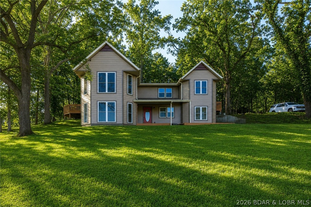 Back on the market at no fault of the Seller! Opportunities like this are hard to find! This recently updated 4 bed, 3 bath home sits on 18 acres in a prime location next to Lake Valley Golf Course and just 6 minutes from the Camdenton Square. With 1,255 feet of highway frontage, the possibilities here are endless—whether you're looking for a private retreat, hobby farm, or an investment opportunity. The home features granite countertops, double ovens, a gas range, & modern updates throughout, offering both comfort and style. Step outside to enjoy the in-ground pool, perfect for relaxing after a day on the lake or the golf course. The property offers a beautiful mix of open pasture & wooded acreage, along with a pond, making it ideal for animals, recreation, or future development.
A detached 2-car garage provides extra storage for vehicles, lake toys, or equipment. With lake access and a nearby boat ramp, you’re only minutes from enjoying the Lake of the Ozarks lifestyle.