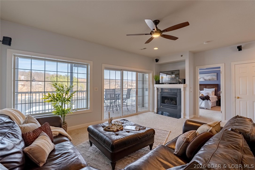 This beautiful walk-in unit is located in a well-known gated condominium complex. Upon entry, you’ll be impressed by the open floor plan and stunning lake views, showcased from the great room with gas fireplace and the oversized screened concrete deck—providing an additional living and entertaining space. Fully furnished with accessories included, this condo is ready for immediate enjoyment. The kitchen features beautiful cabinetry and ample space for entertaining, complemented by a spacious dining area. The lakeside primary bedroom offers direct deck access and an inviting private bath with double vanity, jetted tub, walk-in shower, and walk-in closet. Two additional bedrooms share a full guest bath. The oversized laundry room includes a washer, dryer, and extra storage. This unit includes a boat slip in a deep-water, protected cove and offers elevator access for an easy walk to the dock or the community pool and hot tub, both featuring lake views. The convenient location by land and water places you just minutes from area amenities. The complex also offers a playground, ample parking, making it ideal for full-time, part-time use, or hosting guests.