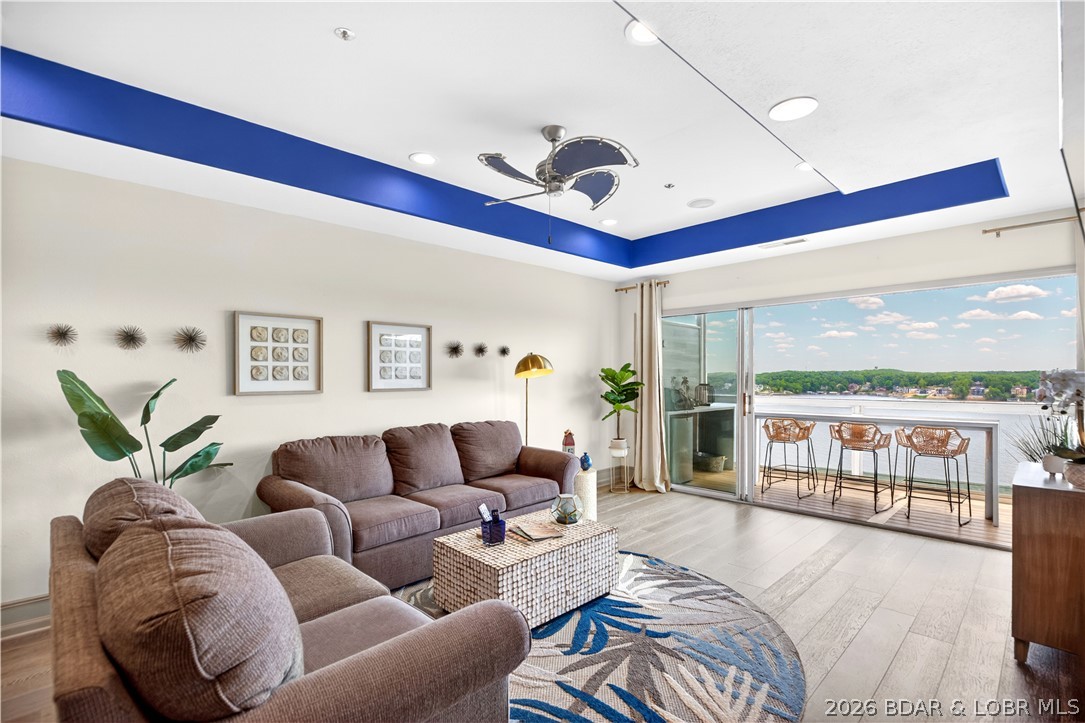 Positioned within the highly sought-after Emerald Bay community, this updated condo captures commanding main channel views, refined interior finishes, and an exceptional indoor-outdoor living experience complete with a 12x32 boat slip. The open-concept interior is layered with upscale details including tray ceilings, updated flooring, designer backsplash, stainless steel appliances, and an inviting breakfast bar that anchors the kitchen and living space. Expansive multi-panel sliding glass doors fully open to the screened lakeside deck, blurring the line between indoor comfort and outdoor entertaining. Elevated above the water, this remarkable space features composite decking, a fireplace, mounted TV, and sweeping panoramic views. The private primary suite offers direct deck access and a custom walk-in closet. Offered fully furnished and turnkey, this residence is ready for immediate enjoyment. Included are boat slip F13 in Dock F with a 6500 lb hoist and storage unit #28. Emerald Bay amenities include pools, tennis courts, clubhouse access, and a central lake location moments from waterfront dining, golf, and entertainment.