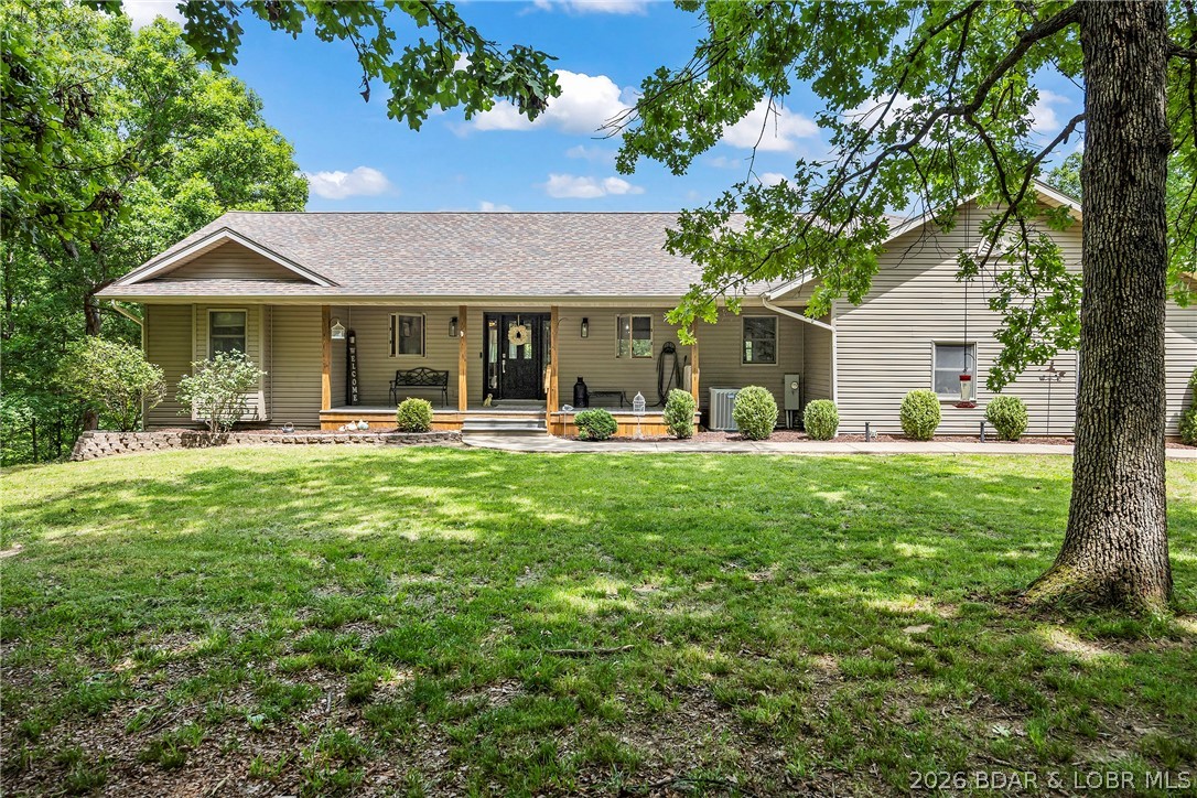 Country living on 20 acres within the city limits of Laurie. Enjoy privacy and Mother Nature with the convenience of being close to city amenities, public golf, movie theater and restaurants. This comfortable home has everything you are looking for including a private in ground swimming pool. This open floor plan features living on the entry level. The large master suite has 3 walk-in closets, his and her sinks and jetted tub. The lower level has a family room, exercise room, storage and additional bedrooms. In addition to the attached garage there is a seperate 18X27 workshop. The updated kitchen has stainless appliances, (micro is brand new), newer counter tops and custom cabinets. The main level features 2 additional bedrooms and 1 bath. The dining room walks out to a screened deck which overlooks your 16X32 pool. The perfect spot to entertain. Call for your private viewing today.
