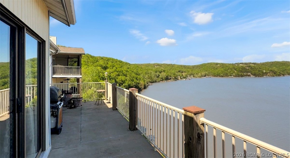 Welcome to your dream lake escape at the 8-mile marker of the Big Niangua arm at Lake of the Ozarks! This 3 bed, 2 bath top-floor condo delivers breathtaking panoramic views that truly steal the show. Step inside to an open-concept floor plan designed for both comfort and entertaining, featuring custom cabinetry, a beautiful custom fireplace, and seamless flow to a spacious deck, perfect for soaking in those unforgettable sunsets over the water. Enjoy resort-style living with incredible amenities including an outdoor pool, clubhouse with whirlpool, fitness center, sauna, and billiard room—everything you need for relaxation and fun night at your fingertips. Ideally located near some of the lake’s most sought-after destinations, you’re just minutes from outdoor adventure at Ha Ha Tonka State Park, live entertainment at Ozarks Amphitheater, and local favorites like The Cave Restaurant, NautiFish Rum Bar, and Larry's On the Lake. Whether you're looking for a full-time residence, weekend getaway, or investment property, this one checks every box—location, space, and those unbeatable views!