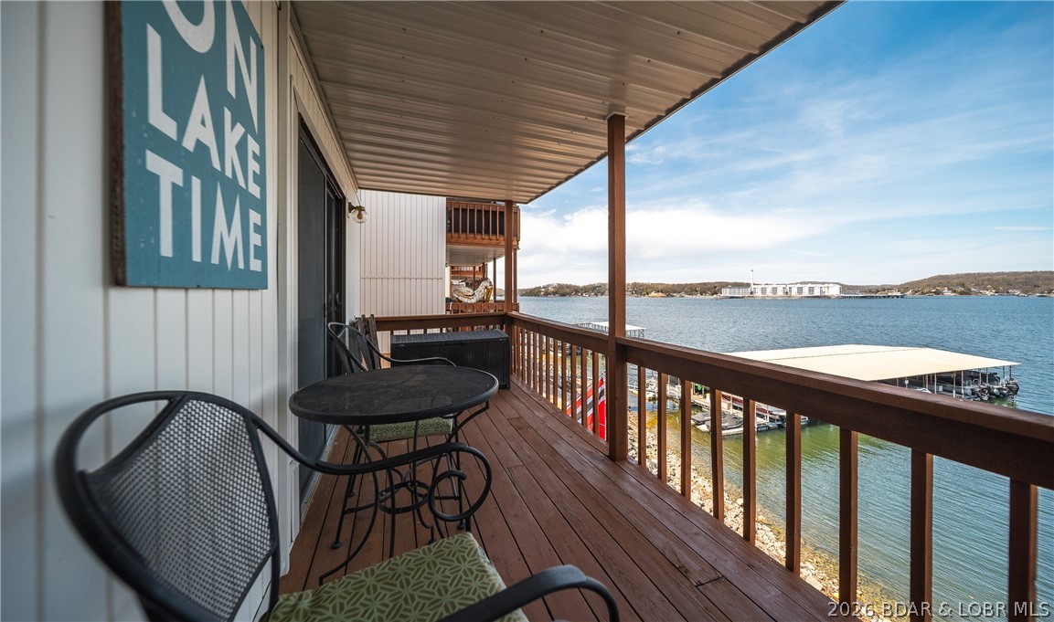 Offered at a new and improved price! Experience the ultimate “wow” moment the instant you step inside this beautifully maintained, turnkey lakefront retreat. Ready for short-term rentals, this 2-bed, 1-bath condo offers incredible versatility as a lucrative investment, low-maintenance getaway, or refined weekend escape. Panoramic water views greet you as you cross the threshold, delivering an immediate connection to the lake lifestyle. Just steps from the water, the outdoor amenities are an absolute dream for boaters. The included dock features a 10 x 24 boat slip equipped with a heavy-duty, remote-operated 4,000 lb Poly Lift, alongside 2 dedicated PWC spots. Inside open-concept layout maximizes the water views, beautifully accented by engineered hardwood floors & custom tile work. The property is offered truly turnkey & comes fully furnished—including multiple beds & a sofa sleeper—making it immediately ready for you or your rental guests. Exceptional pride of ownership is evident throughout, backed by peace-of-mind updates like the brand-new water heater (2024) & HVAC (2015). Completely move-in ready for the season, this rare waterfront gem is primed and ready for its next owner.