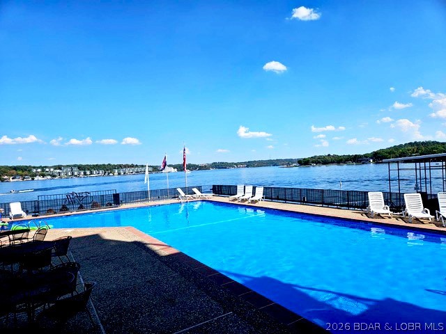 Enjoy the privacy and comfort of a home without the maintenance in this exceptional lakefront residence. With stunning water views, the open floor plan features two lakeside primary suites, a dedicated dining area, and a functional galley kitchen. The true showpiece is the spectacular 54-foot screened deck—an expansive outdoor living space offering panoramic lake views and plenty of room for entertaining all in comfort. Thoughtfully maintained, the home includes a newer HVAC system with humidifier, newer water heater, and oversized Pella sliding doors providing excellent energy efficiency, insulation, and sound reduction. Convenience is built into every detail with two private garage parking spaces near the entry and elevator access directly to the waterfront. Located in a family-friendly community with private docks, two swimming pools, and tennis courts, this property offers an outstanding lake lifestyle at an exceptional value. Sold "as seen," sellers have already relocated due to health changes, creating a rare opportunity to purchase a premier lakefront property at a significantly reduced price. Schedule your private tour today and discover one of the best values on the lake.