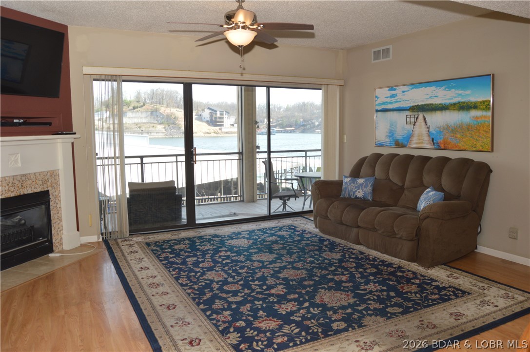 Great value just in time for summer FUN! Sellers have moved on to their next chapter and are anxious for new owners to begin making memories at this awesome 3 bedroom 3 bath condo with huge lakeside deck. Offering all of the comfort and privacy of a home with none of the hassle, this condo is perfect for full time living or investment property. It includes 2 very rare private parking spots in covered garage with easy access via new state of the art elevator or one flight of stairs. The open floor plan features 2 lakeside suites and covered deck overlooking your views of cove and main channel. Your 10x28 boat slip is easily accessible with lakeside boardwalk leading to resort style pool on point. Numerous features for easy lake living including hard surface flooring, galley style kitchen with large breakfast bar, coffee station, and electric insert fireplace for heat and ambiance. Two baths have been updated with custom tile showers. The Falls is conveniently located on Horseshoe Bend just a short drive to shopping, restaurants, and medical facilities. and a short boat ride to numerous lake entertainment complexes including Bagnell Dam Strip offering tons of fun for everyone!