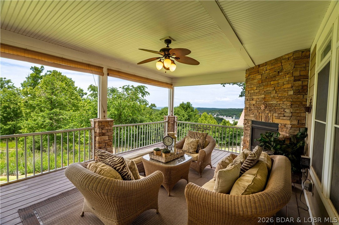 Located in a highly sought-after gated, golf cart-friendly community with incredible amenities, this beautifully designed Craftsman-style home offers over 3,500 sq. ft. of living space in the desirable Camdenton School District—less than 10 minutes to schools and shopping! Residents enjoy a true neighborhood feel with a clubhouse, pool, tennis/pickleball courts, and street lighting. This spacious 4-bedroom, 4-bath home showcases quality finishes including granite countertops, hardwood flooring, stainless steel appliances, tile backsplash, coffered ceilings, and a warm gas fireplace. The expansive primary suite offers a private retreat with a sitting area and spa-inspired bath featuring a jetted tub. Designed for relaxing and entertaining, enjoy the impressive 438 sq. ft. screened porch with composite decking and a cozy gas fireplace just off the dining area—perfect for year-round enjoyment and beautiful views. The lower level features a second family room, full kitchen/bar, and access to a covered concrete patio and flat backyard. Beautiful landscaping and an automatic irrigation system complete this exceptional home offering comfort, convenience, and community living