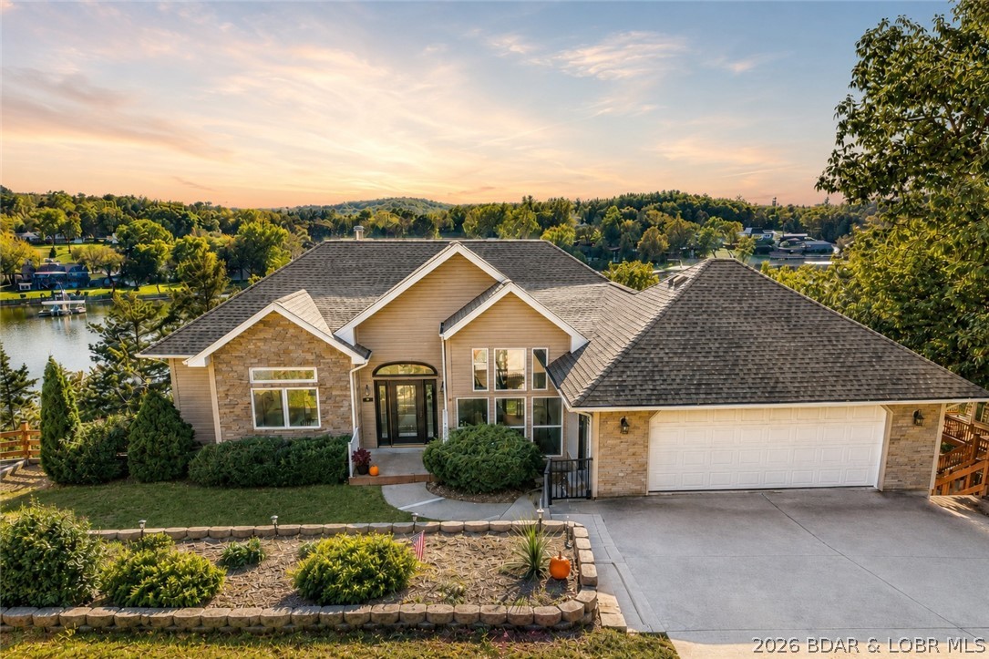 MOTIVATED SELLER...Welcome to Minnow Brook, on the Big Niangua arm of the Lake of the Ozarks. Located on the quiet side of the lake, this stunning 5 bedroom, 2.5 bath lakefront home with 3,416 SF is just minutes from shopping, fine dining, schools and 2 top golf courses, Old Kinderhook & Lake Valley. Open concept living with picturesque lake views throughout. The main level consists of a grand entry, cozy great room with fireplace, gourmet kitchen with granite countertops, elegant dining area with lake views, half bath, office/den, and large open master suite with surround windows, private double vanities and walk-in shower & walk-in closet. Venture down to the lower level consisting of the second living area, wet bar for easy entertaining, four bedrooms and large bath. With 2 levels of composite decking and screened porch, outdoor living is a breeze. The 100’ of lakefront, large martini deck and firepit are just steps from your private dock w/swim platform and deep water. Quality built home in a vibrant neighborhood, you have found home!