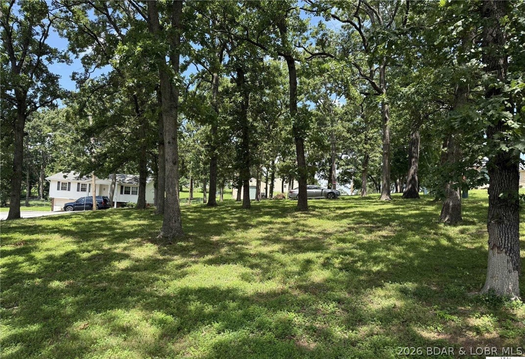 Great building lot in Warsaw! Nice big, shaded corner lot, just 1.4 miles from a boat ramp on the Lake of the Ozarks.