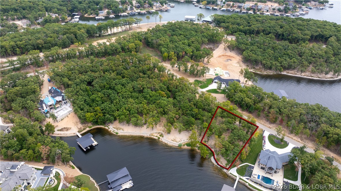If you want the most exclusive address at Lake of the Ozarks, this is it! This peninsula in the Villages is quickly becoming known as "the ultimate lake address" With over an acre of gentle terrain and 220' of beautiful shoreline, the possibilities are unlimited. Large dock envelope is perfect for the dock of your dreams. Multi-million dollar homes are being built all around this spectacular setting. Everything you need is just across the community bridge. Only minutes from fun activities on Bagnell Dam, multiple groceries stores, shops, restaurants and medical facilities by land offers convenient living. Hop in the boat and you can be at multiple water entertainment complexes including Dog Days, Redhead Yacht Club, Backwater Jacks and for that fine dining experience check out the Reserve! Combine this with the adjacent lot and you have a place to build your lake masterpiece! Don't miss the opportunity to own one of the last premier parcels at the Lake.