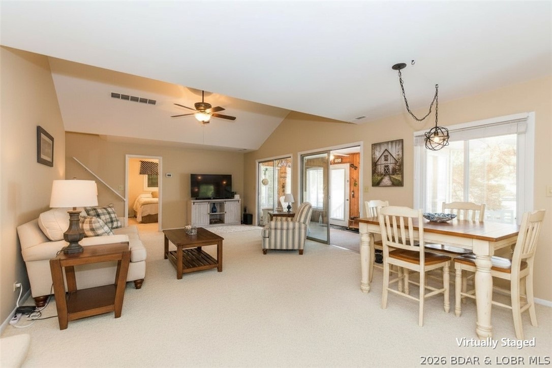 Classic lake vibes with the modern upgrades you’ve been looking for! This beautiful 3-bedroom, 1.5-bath home is ready to impress! Pride of ownership is evident at every turn, with stylish updates and thoughtful touches throughout. The main level welcomes you with a charming sunroom (complete with A/C), updated kitchen featuring tile floors, glass tile backsplash, and updated lighting, plus a bright, open living room with soaring vaulted ceilings. The main-level primary bedroom offers convenience, while two additional bedrooms provide the perfect balance of privacy. The main bath includes both a tub & a walk-in shower. Storage is a standout here, with a spacious lower-level workshop/storage area & additional exterior space for all your lake gear. Step outside & soak up true lake life. Multiple decks, a 2-well dock with boat and PWC lifts, swim platform with wet steps, & 75 feet of stunning stone seawall with easy walkout access. Bonus perks include a second-tier lot with a double carport, HVAC (2019), water heater (2022), and a regularly inspected engineered septic system. This one perfectly blends timeless lake charm with modern comfort. Your lakefront lifestyle starts here!