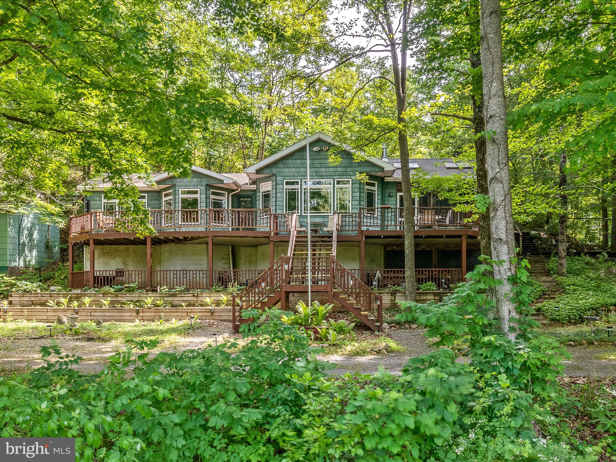 Experience serenity along the Cacapon River at this fully renovated cabin, boasting over 1300 square feet of living space and natural light galore through numerous windows and skylights.  Unwind on the deck or screened porch, taking in the soothing sounds of the flowing water and birds singing.  Indulge in the ultimate living experience with this impressive home , offering a stylish kitchen, dining area, and living room complemented by a cathedral ceiling and a cozy wood burning fireplace.  The property is further enhanced by 2 sizable bedrooms, 2 immaculate full bathrooms and a convenient utility room.  Benefit from the efficiency of a heat pump/central air. This home comes equipped with the majority of the furnishings.  Your clothes are the only essential item you will need.  .41 acre.  *Flood elevation certificate states the existing cabins 1st floor is 2 feet above the 100 year flood elevation.
