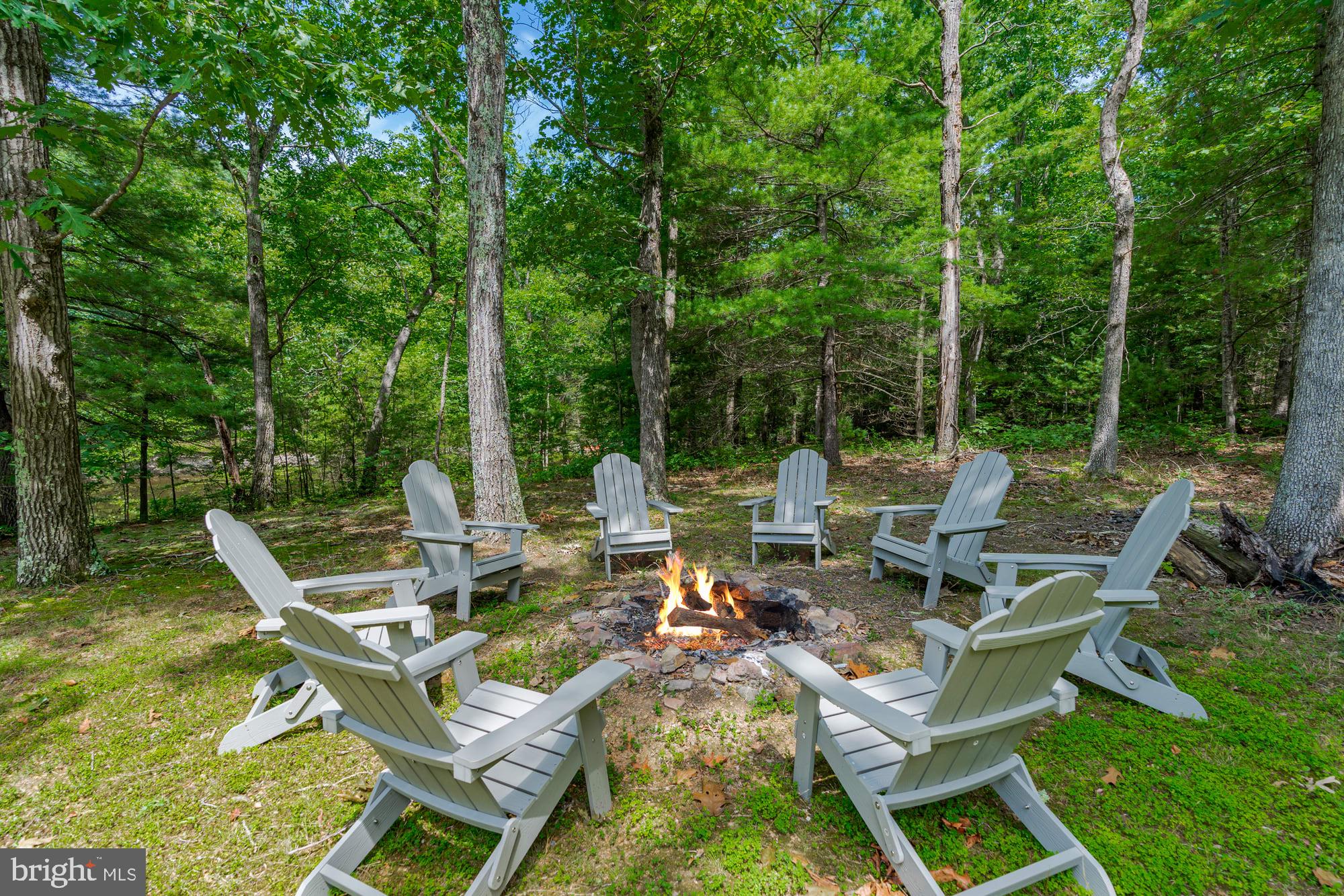 Updated cottage nestled in the woods on a private pond, and only 15 minutes from downtown Berkeley Springs!  Features modern finishes throughout, and includes a spacious deck stretching the full length of the home, a cozy electric fireplace, vinyl plank flooring, and a galley-style kitchen. Outside you’ll find a screened-in porch, covered patio, and hot tub – and of course the small pond just steps from your door.  The seller spent over $63,000 upgrading the property.  As a vacation rental it has generated rental revenue for years ($38,000 over the past year), and can come with an existing property manager and cleaner.  Hot tub and all-new furniture optional, available for purchase.  See seller docs for a summary of rental history and financials.  $1,000 buyer credit if you continue using the same property manager.  Perfect vacation home or investment property!