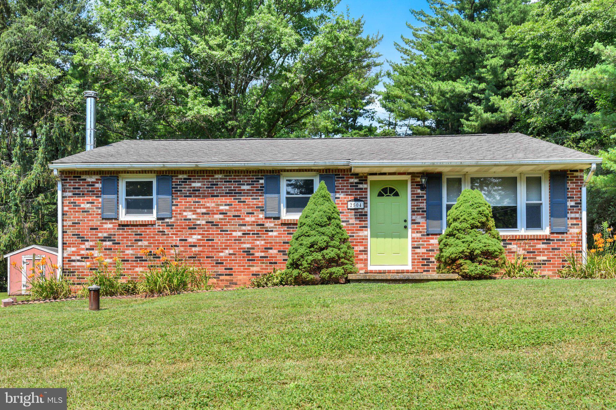 Come see this charming starter rancher on a beautiful lot just minutes from Hampstead. Enjoy a quiet country setting at a great price, with convenient commuting options north and south. This rancher has been freshly painted throughout in neutral colors. The main level features new engineered hardwood flooring in the living room and hallway, along with new carpet in the bedrooms. A full hall bath and a half bath off the kitchen near the back door add convenience. The kitchen offers attractive cabinetry and recently updated stainless-steel appliances. The lower level includes a spacious family room with a wood stove, an additional room suitable for a playroom, office, or guest room, plus a laundry and storage area. The beautiful backyard includes a covered patio off the kitchen overlooking the yard—an easy space to finish for added living area. Two sheds and a large one-car detached garage provide excellent storage. The yard offers a relaxing place to unwind after a long day. The roof and HVAC system are newer, and the wood stove adds comfort during cooler winter months. A few small updates, such as new kitchen flooring and replacing the family room carpet, would further enhance this already desirable property.