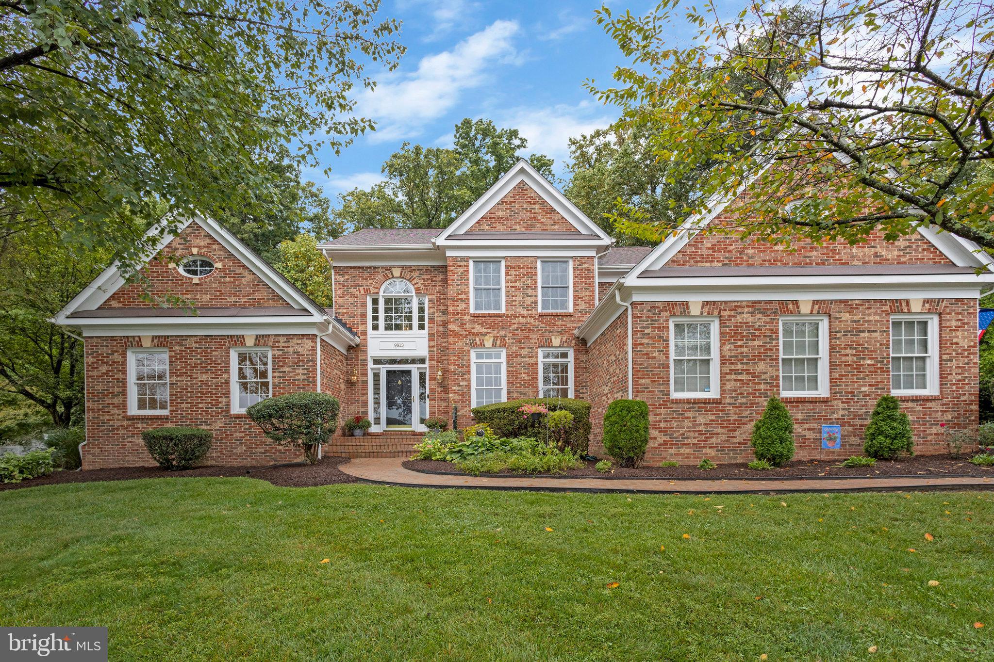 Welcome home to 9813 John Robert Way in Fairfax, Virginia. This stately residence with over 5400 square feet on three sprawling levels features 4 bedrooms (currently lower level room is used as a  5th bedroom , however there is no direct outside egress), 4.5 bathrooms, a main level primary suite, a delightful kitchen open to the breakfast area and family room, a two-sided  fireplace between the family room and sun room, hardwood floors, skylights, oversized transom windows, vaulted ceilings, a screened porch, and two car garage. Situated on an almost ½ acre beautifully landscaped and well-maintained lot at the end of a quiet cul de sac, this elegant home is part of the esteemed Woodson High School Pyramid.    Move-in Ready - freshly painted, new carpeting on main and upper levels, and newly refinished hardwood floors. 

As you step inside, a two-story windowed foyer and gleaming hardwood floors welcome you, creating an inviting ambiance. Positioned at the front of the house, the living room features high ceilings and generous windows and with french doors to separate it from the rest of the home.   This versatile room would make a distinguished large private office.

The kitchen is a chef’s delight, offering white cabinetry, quartz countertops, stainless steel appliances, an island with gas cooktop, double wall ovens, a French door refrigerator and a pantry closet. A conveniently located laundry room off the kitchen and entrance to the two-car garage add to the functional layout. The kitchen seamlessly flows into the breakfast area, family room and dining room.

Large windows all along one wall and two skylights create a bright and sunny breakfast area. From the breakfast room you can enter the screened porch with peaceful and serene views to the private backyard and deck access - a delightful spot for relaxation, reading, coffee, or an evening beverage with friends.

The family room and sunroom share a two-sided fireplace, flanked by glass French doors. The airy sunroom with oversized windows, skylights and vaulted ceilings, looks out to the deck and back yard.

The main level also hosts a luxurious primary suite with vaulted ceilings, large transom windows, and two walk-in closets, accompanied by a serene primary bathroom with a dual vanity, soaking tub and separate shower. A convenient hall half bath and closet complete the freshly painted main level.

Upstairs you’ll find three bedrooms, one with its own bathroom, the other two sharing a bath, although each featuring their own vanity area.

The lower level offers a very spacious rec room and game room, a bonus room, (potentially a quiet home office or exercise room) a full bathroom, and ample storage space, with the added convenience of a outside entrance leading to the backyard.

Just off 236 between Woodson High School and at the edge of Fairfax City, 9813 John Robert Way is conveniently located and walking distance to shopping, restaurants, local businesses, Woodson and Frost schools, and public transportation. Don’t miss the chance to make this exceptional property your own. Schedule your showing today.   9813 John Robert Way is a red brick home at the top of the cul de sac with a basketball hoop on the right side of the driveway.    Ring doorbell with audio/video .  Agent related to owner.   Information deemed reliable, but not guaranteed, buyer should verify all information.