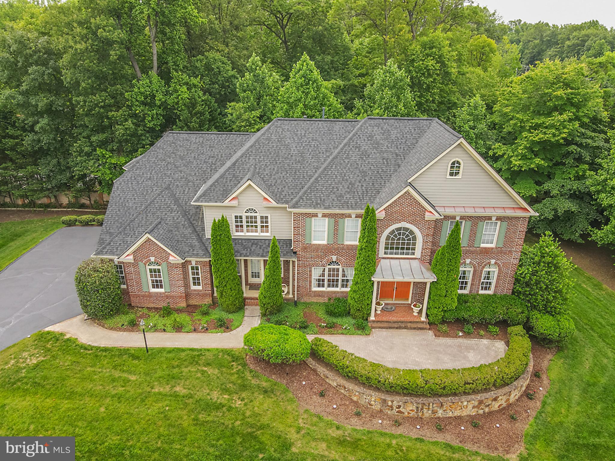 STUNNING AND SPACIOUS 7116 Sq. Ft. 3 level home with 5 bedrooms, 4 full bathrooms with 2 half baths, laundry room and 3 car garage! This beautiful property sits on a little over 3/4 acre in a quaint neighborhood minutes from Tysons Corner, Langley School District, Reston Town Centre, the new upcoming Dulles Metro, Dulles Airport, and Leesburg Outlet. The main level features a full kitchen, including a double oven, dishwasher, island cooktop, double sink and more! 18 Ft. ceilings and bay windows in the family room which also includes a wood burning and remote stone gas fireplace! Gorgeous dining room with a serving pantry, private office, and a living room. The top-level features 3 bedrooms and a master suite with a private living room, his and her bathroom, jacuzzi and 2 walk-in closets and a shoe closet. Private backyard with a full deck leading from the kitchen and access to the lower level patio and a walk out basement. In the lower level, there is an Au Pair su ite with a full kitchen, a gas fireplace, gym, full bathroom, home theater, living and storage room. Brand new roof and septic pumps. Home also has city water and gas! New hot water heater and new HVAC two zone systems.