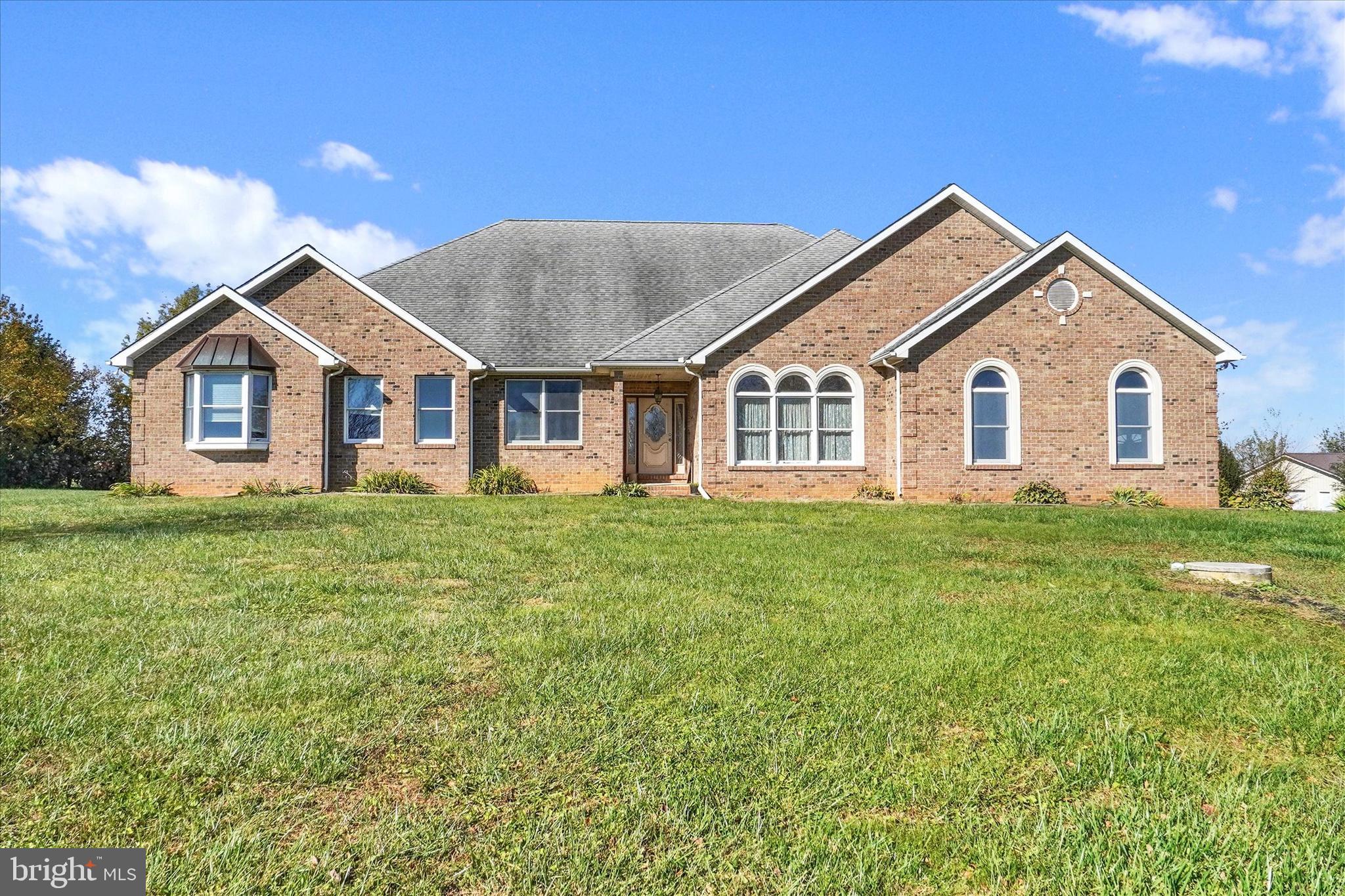 Large one story home on 33  fantastic acres. This home has 3 very big bedrooms, huge kitchen (20 x 28) that attaches openly to a great big (22 x 24) sunken family room. All brick built in 2001. Enter the home from the road via a long tree lined blacktop driveway to the homesite sitting high on the hill. There are 2 parcels included in the sale with 2 additional building rights so it is possible for subdivision and more than one family to live on the property. Nearly all the 33 acres are tillable and would make a wonderful produce farm. The home is heated by a  heat pump with propane backup. Location Location Location