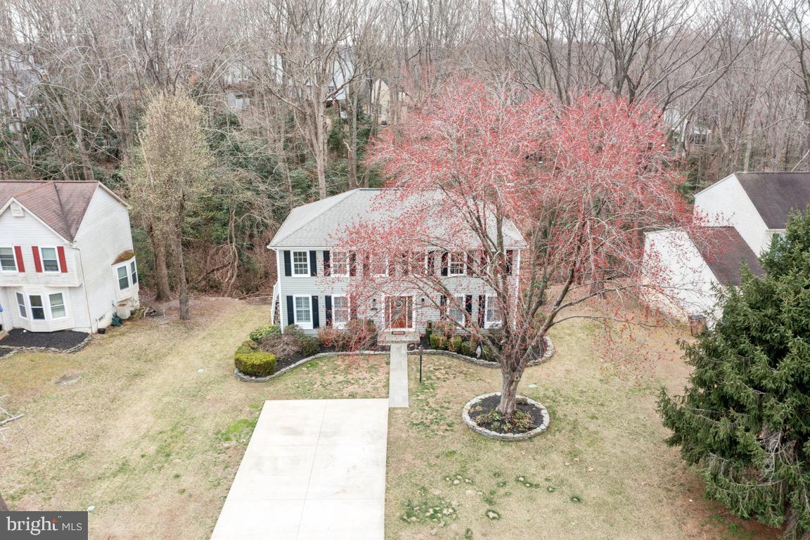 Welcome to this gracious 5-bedroom, 2.5-bath colonial home in Aquia Harbour. This home offers over 2400 square feet of move in ready, finished living space. As you approach the home you will find a flat cement driveway, an elegant slate path & stoop leading to the glass inlaid front door. You are greeted by beautiful hardwood floors throughout the main level. 
The light-filled, renovated kitchen features stainless steel appliances, white cabinetry, extended counter space, a wine bar, pantry and convenient laundry closet. The breakfast room is bright and inviting, while the spacious dining room is perfect for formal meals. A sunny formal living room comes with plantation shutters and shelving and offers quite space to relax and read a book. The family room is highlighted by a stone, wood-burning fireplace. French doors open to a large, low maintenance composite wood wrap around deck, overlooking the wooded back yard. 
Upstairs, you'll find five bedrooms. The primary suite has a large walk-in closet with ample storage space and the updated primary bath offers a large soaking tub, separate shower, double sink vanity, and extra storage. The newly updated second full bath features extended counter space and a tub/shower combo with new tiles and fixtures. 
The lower level is unfinished but provides plenty of room for storage, a workshop or a home gym. It is a blank canvas for customization to suit your needs. The basement door walks out to a paver patio and is another way to access the backyard and enjoy the natural beauty of this secluded spot. The yard is also equipped with an inground irrigation system. This house has been lovingly cared for over the years. The age of the Roof is unknown, HVAC 2019, Hot water heater 2020. The windows, while not brand new, have been replaced and are not original.
The neighborhood is packed with fantastic amenities, including nine parks, tot lots, walking/jogging trails, a marina, stables, a golf course, a police department, and a preschool. Pool memberships are also available in the community. With easy access to I-95, commuter lots, and shopping, this home is perfectly located for convenience and leisure.