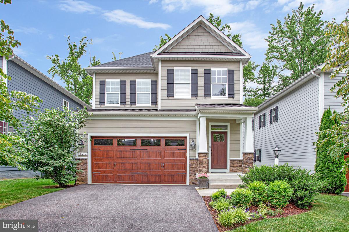 Showcasing timeless elegance and exceptional craftsmanship, this stunning Hardi Plank and stone Craftsman residence seamlessly blends sophisticated design with everyday comfort. Offering 3 bedrooms and 2.5 baths, the home welcomes you with rich hardwood flooring throughout the main level and an inviting family room highlighted by a gas fireplace and custom built-in shelving. Designed to impress, the gourmet kitchen is a true culinary masterpiece featuring a Wolf Professional 36-inch induction range, an expansive granite center island, a walk-in pantry, under-cabinet lighting, a designer tile backsplash, and beautifully crafted maple shaker-style cabinetry. The adjoining dining area is generously proportioned and bathed in natural light, creating an ideal setting for both intimate gatherings and effortless entertaining.
The serene primary suite serves as a private retreat, complete with a spa-inspired statement bath and two spacious walk-in closets. Two additional generously sized bedrooms provide comfort and versatility for family or guests. The professionally finished lower-level office offers the perfect work-from-home environment, while the expansive unfinished area presents outstanding potential for future living space, recreation, or storage. Thoughtfully designed custom closet systems throughout the home provide exceptional organization. Outdoor living is equally captivating. A spacious deck overlooks a tranquil wooded backdrop, creating a peaceful sanctuary for morning coffee, evening relaxation, or bird watching. The rear yard is fully enclosed by a 6-foot vinyl privacy fence and enhanced by beautifully curated, low-maintenance landscaping, offering both beauty and privacy. Perfectly situated just minutes from Towne Centre, Historic Downtown Annapolis, and Annapolis Harbour Center, this exceptional residence offers an enviable combination of luxury, convenience, and enduring style in one of the area's most desirable locations.