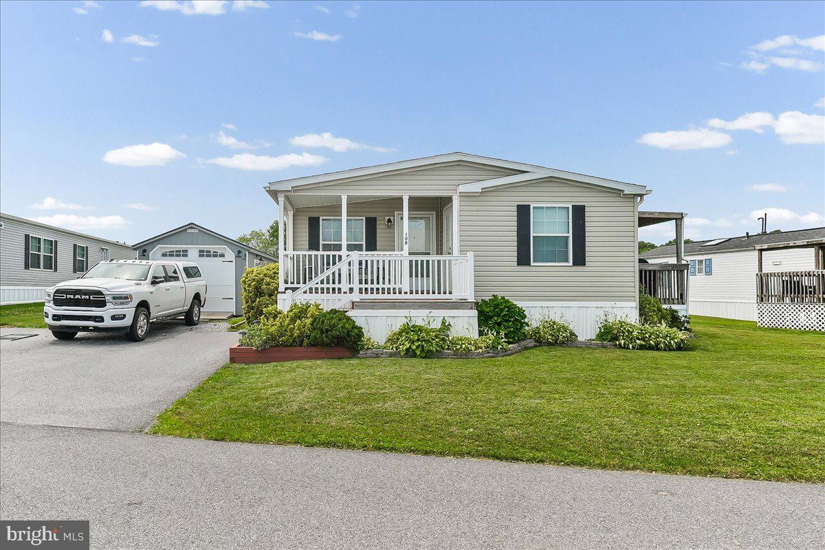 Welcome home to this beautifully maintained 3-bedroom, 2-bath double-wide manufactured home, built in 2014 and located in a picturesque country setting within a desirable community. Featuring an open-concept floor plan, this home offers spacious living areas enhanced by modern updates and warm rustic finishes that create the perfect blend of style and comfort.

Enjoy outdoor living with three separate decks, providing plenty of space for relaxing, entertaining, or taking in the peaceful surroundings. A large storage area with private access through the porch adds convenience and functionality, while an additional storage shed offers even more space for your belongings.

One of the property's standout features is the detached oversized garage—a rare and highly sought-after amenity in a manufactured home community—providing ample room for vehicles, hobbies, tools, and extra storage.

With its attractive updates, generous storage options, and beautiful country atmosphere, this move-in-ready home is waiting for its new owner. Don't miss the opportunity to make this exceptional property your own!