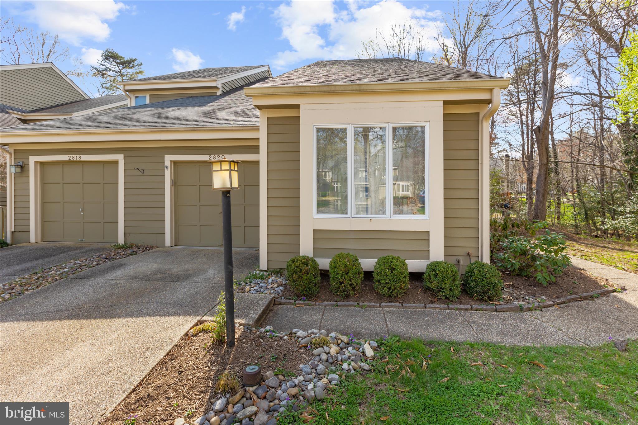 OPEN HOUSE CANCELED. UNDER CONTRACT. Welcome to 2820 Pennypond Ln, a rare end-of-row townhome occupying a premium position within the neighborhood. The home is tucked against a private, natural buffer that provides a surprisingly peaceful and private setting not typically found in a townhome community.  The home’s side-entry design enhances the sense of privacy, opening into a bright, voluminous floorplan defined by vaulted ceilings and recessed lighting. The main level is anchored by upgraded engineered distressed hardwood flooring and a sun-filled living and dining combination.  A wood-burning fireplace serves as the cozy centerpiece of the living area, while the updated kitchen (featuring new cabinetry installed in 2021, modern appliances, and skylights) is a bright, functional workspace. Both the kitchen and living room offer direct access to an expansive rear deck, perfect for entertaining or quiet morning coffee against a backdrop of mature trees.
The thoughtful layout provides true main-level living, featuring a primary suite with a vaulted ceiling, a large windows, a walk-in closet, and a spa-like bath with a double vanity and walk-in shower. A guest powder room completes this level. Upstairs, two additional generously sized bedrooms share a second full bath. The finished lower level adds significant additional living space and convenience with a half bath, a built-in wet bar, and extensive storage capacity.  Riva Trace is a premier lifestyle community that perfectly balances nature with accessibility. Residents enjoy exclusive amenities, including a private pier on the South River for kayaking and paddleboarding, tennis and basketball courts, and miles of scenic walking trails. You are strategically positioned just minutes from the Annapolis Towne Centre, world-class dining, and major commuter routes including I-97 and Route 50.  Rarely does a home combine this level of privacy with such a vibrant community lifestyle and convenience. Schedule your private tour today and see why this is a premier choice for a lifestyle of convenience and enjoyment in Annapolis!