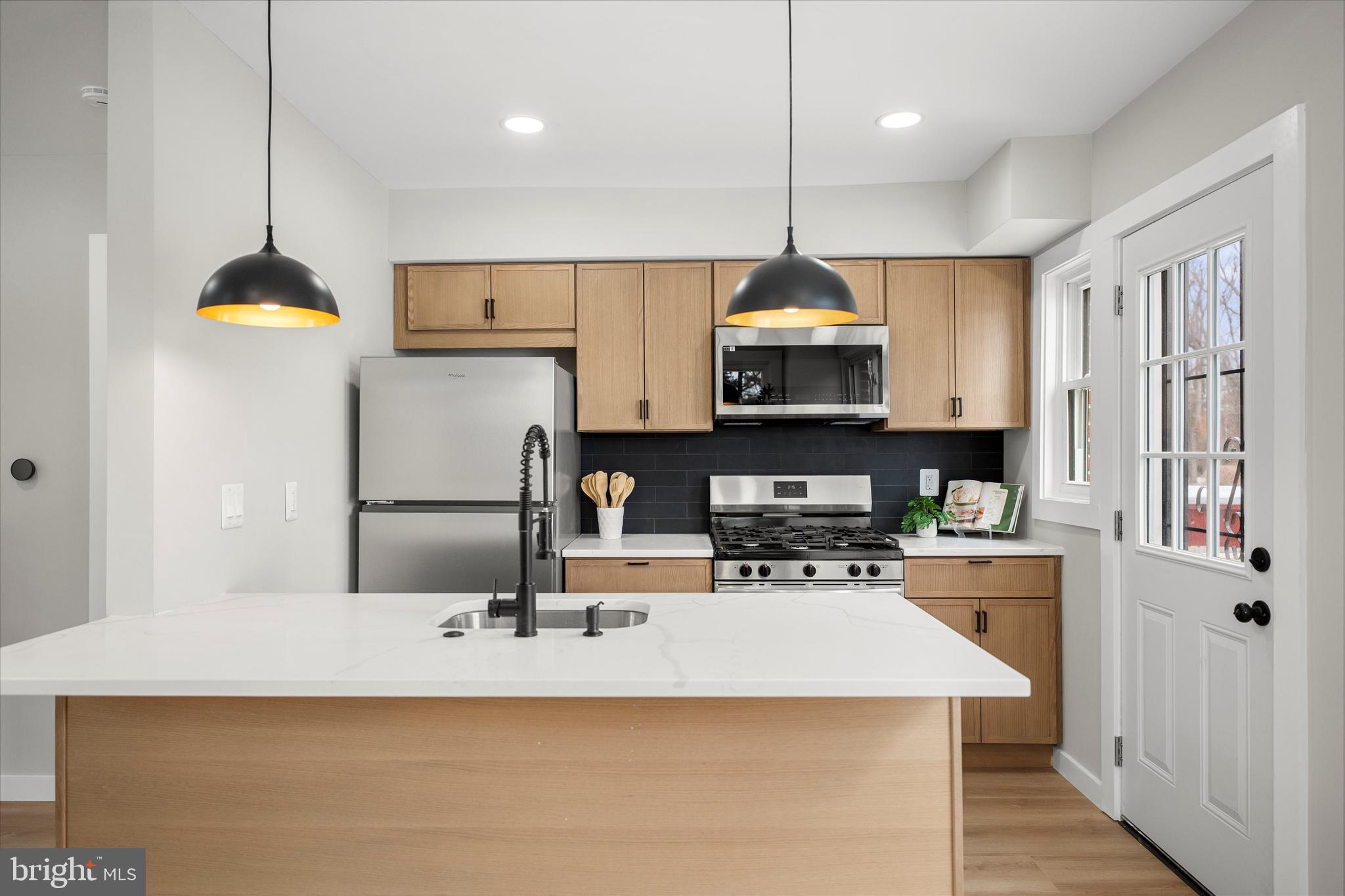 Welcome to this fully remodeled corner-unit home, thoughtfully redesigned by a reputable designer, where nothing was overlooked. This charming two-bedroom, two-bathroom residence blends modern updates with everyday comfort and functionality. The lower-level room can be used as a third bedroom. Step inside to an inviting open floor plan filled with natural light, highlighting brand new flooring, fresh paint, and seamless flow between the living, dining, and kitchen areas. The fully remodeled kitchen features new cabinetry, countertops, stainless steel appliances, and gas cooking. The home offers a finished basement with a full bathroom and a separate private entrance, making it ideal for an additional bedroom suite, private office, guest space, man cave, or potential additional income. Major upgrades include new windows, new roof, new deck and fence, new HVAC system, new water heater, and new electrical panel, offering true peace of mind. Outside, enjoy exceptional privacy. This is the only home backing directly to a park, ensuring permanent open views with no future construction and no neighbors behind you. A brand new oversized deck, fully fenced yard, and large shed create the perfect setting for entertaining or relaxing. Hosting is easy with ample parking available, even for larger gatherings. Prime location just five minutes to West Hyattsville Metro, walking distance to Metrobus, close to downtown Hyattsville, Aldi, Lidl, parks, shops, and restaurants, with easy access to Washington, D.C. This home is truly move in ready, private, and thoughtfully upgraded, offering an ideal place to live. The property requires flood insurance.