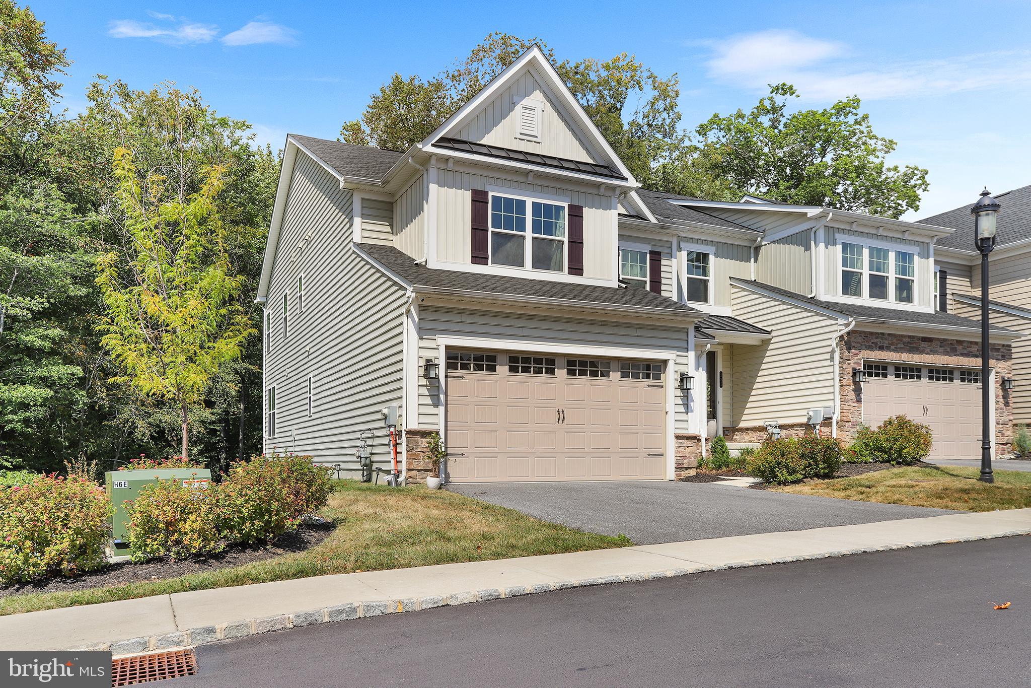 Welcome to Ponds Edge!  This 4 bedroom, 3.5 bath end-unit townhome in the award-winning Rose Tree Media School District offers modern living with style and convenience. As an end unit, you’ll enjoy extra natural light, added privacy, and serene wooded views from the rear deck and walkout basement. Inside, hardwoods flow throughout the open floor plan. The gourmet kitchen features quartz countertops, stainless steel appliances, and an oversized island—perfect for everyday living or entertaining. The spacious family room is anchored by a gas fireplace, while the dining area provides room for gatherings. Upstairs, retreat to the primary suite with a walk-in closet and a spa-like en suite bath, complete with a designer tiled shower and dual vanity. Three additional bedrooms, a full hall bath, and a convenient laundry room complete the upper level. The finished walkout basement adds valuable living space with a full bath, ideal for a media room, gym, or play area. Enjoy community amenities including a clubhouse and fitness center, plus the unbeatable location—close to Media Borough restaurants, shopping, and Septa’s Wawa Station for easy access to Center City. This move-in ready home combines luxury, privacy, and convenience in one of Delaware County’s most sought-after communities.