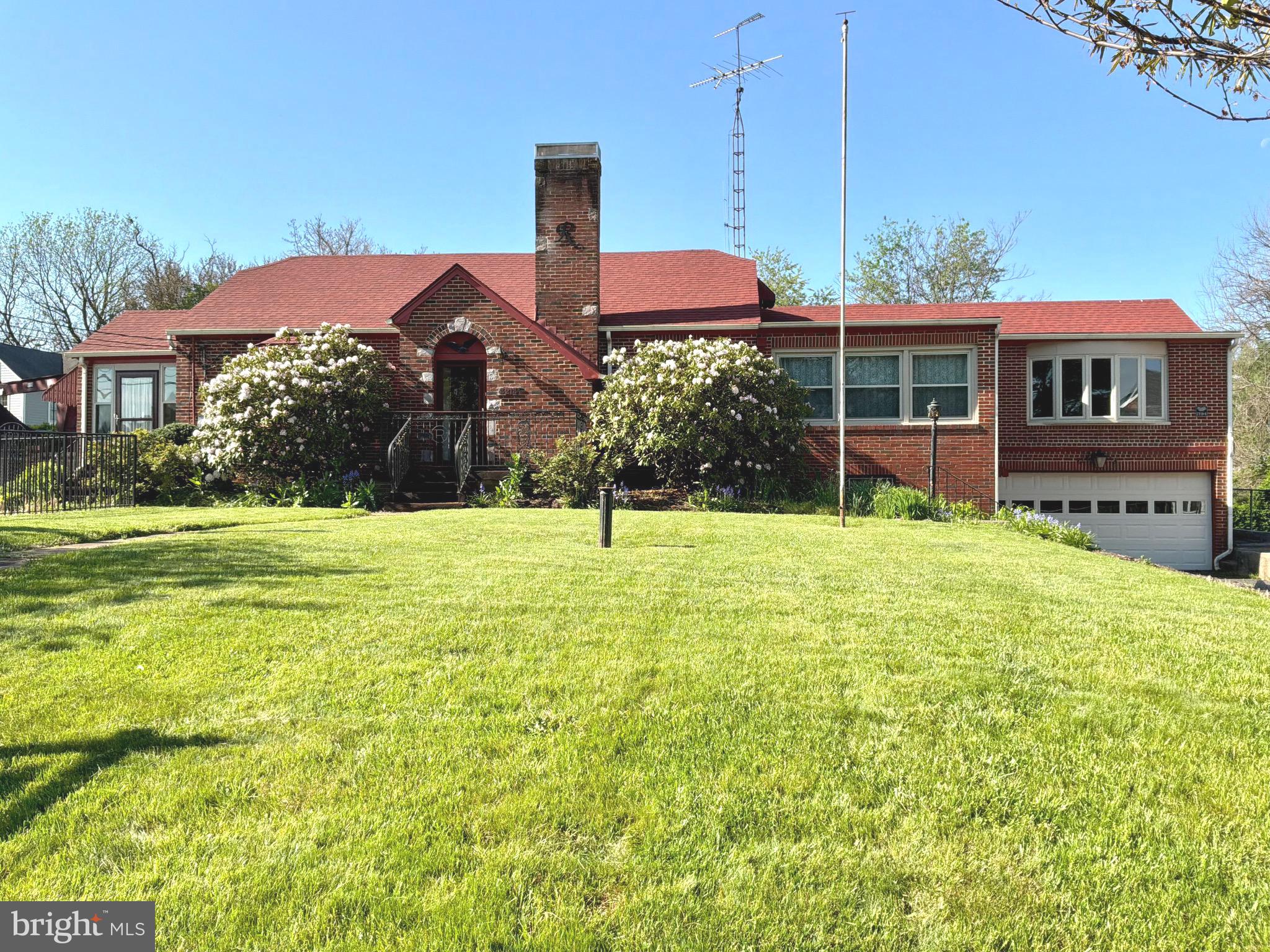 Price Improvement! This iconic 1937 Brick Tudor Revival residence and adjacent additional structure are being sold together, situated on two separately deeded parcels that share a well and septic system.

The Tudor Revival home has been freshly painted and offers timeless character blended with thoughtful updates throughout. The kitchen features stainless steel appliances, a new cooktop, custom cabinetry, and granite countertops. The formal dining room boasts built-in china closets and an oversized bay window, while the inviting living room centers around a classic wood-burning fireplace.

The primary suite includes custom wood-paneled walls, an oversized bay window, a walk-in closet plus two additional closets, and a private ensuite bath. A new hot water heater, along with new roofs on both the home and pool house, provides added peace of mind.

The finished basement expands the living space with a recreation room, partial kitchen, office, laundry area with shower, and a half bath—ideal for a variety of residential needs.

Outside, the oversized fully fenced backyard creates a private retreat, featuring an in-ground pool with a new liner installed in 2022, a brick pool house, and a storage shed—perfect for entertaining or relaxing.

The adjacent structure offers substantial additional space and includes notable features such as three-phase 400-amp electrical service, a 4,000-pound jib crane, and existing interior infrastructure. The property is currently zoned R3 and is being sold strictly for residential use. Any future use of the additional structure is subject to zoning regulations, and buyers are encouraged to conduct their own due diligence with the appropriate local authorities.