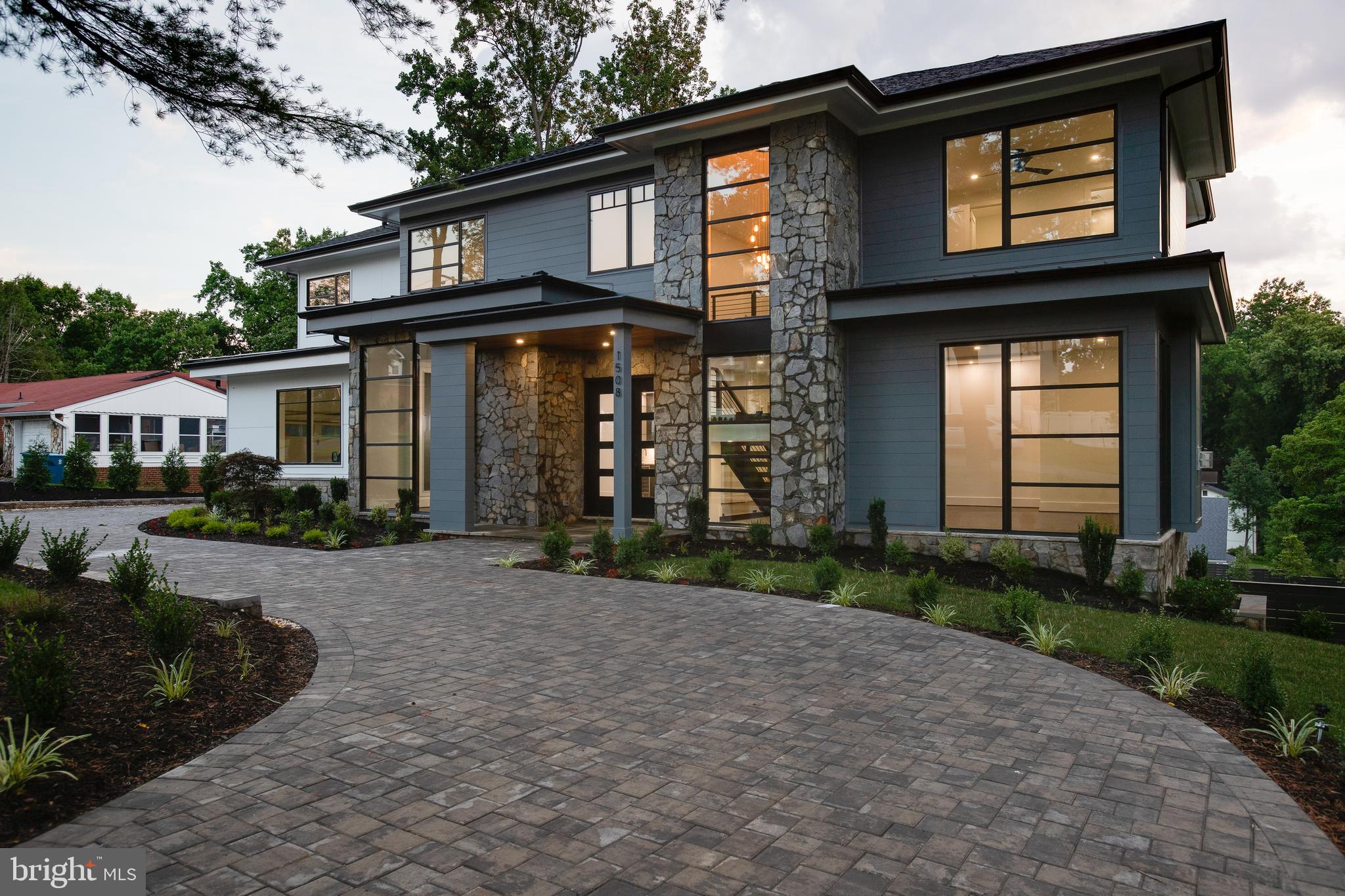 Presenting 1508 Brookhaven Drive, a luxurious residence situated on a large premium lot in the Brookhaven neighborhood. This home boasts dramatic windows throughout flooding the living space with natural light and walls of windows in the main and lower levels overlooking a serene setting. The open concept floor plan has an executive office on the main level, Miele appliances in the grand gourmet kitchen, and a large deck of the family room with access to a screened-in porch. The primary bedroom suite has private access to a rear deck, spa like bathroom, morning bar, and a vast walk-in closet with ample built-ins. The lower level offers a very large recreation room with walkout access to a rear patio, full wet bar with beverage center and wine refrigerator, exercise room, and a large game room. Spacious ensuite bedrooms, ample storage and closet spaces, side loading 3 car garage, and great outdoor entertaining spaces with plenty of room to expand for further recreational purposes are just some of the features this gorgeous home offers.
