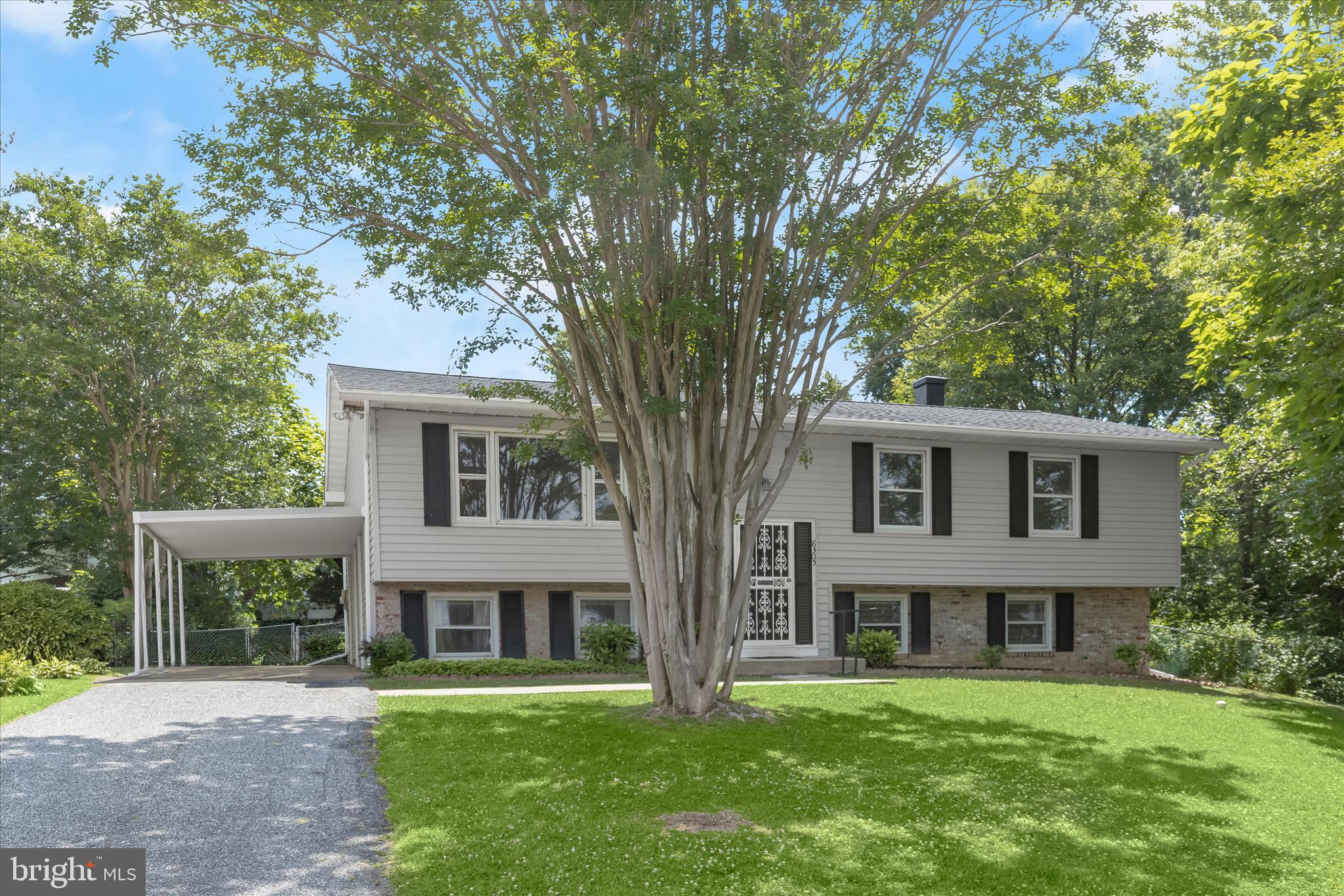 Welcome to this spacious four bedroom, two bathroom home set on a pristine quarter-acre lot in the Overmont Park neighborhood. The main level features rich hardwood floors complemented by a neutral paint theme and an abundance of natural light. An inviting front living room provides an inviting space to relax while the dining room is ideal for hosting gatherings and has access outside to the covered porch overlooking the backyard. Prepare your favorite meals in the eat-in kitchen with stainless steel appliances, a pantry and space for a breakfast table. The main level hosts three bedrooms including the primary, along with a full bathroom. Downstairs, the finished lower level expands the living space. A large recreation room is perfect for entertaining or everyday living, while the fourth bedroom provides versatility and can also be used as an office or den with a walk-in closet. Across the hall is a second full bathroom, and a laundry room with storage space and a utility room complete the lower level. Enjoy relaxing outside in the expansive fenced backyard surrounded by trees for a peaceful setting. There is additional outdoor storage space under the covered deck along with a convenient carport and long driveway. Recent updates including a new refrigerator (2026), kitchen and recreation room flooring (2026), electric range and dishwasher (2024), roof and gutters (2024), exterior and interior paint (2024), HVAC (2022), water heater (2022), and more. Some images have been virtually staged.
