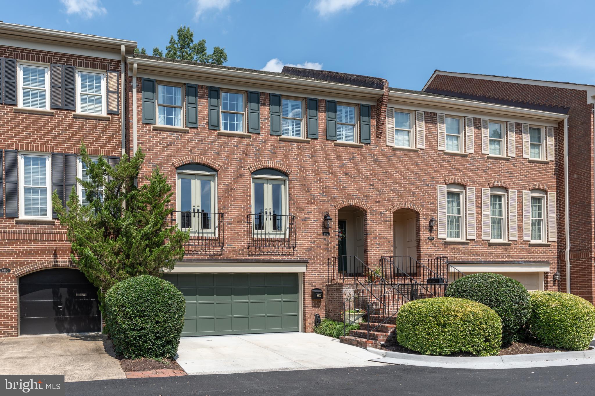 Some homes strive to impress — this one simply exceeds expectations. Located in the sought-after Madison of McLean community, just minutes from Tysons Corner, downtown McLean, and Washington, D.C., this four-level townhome offers over 3,100 square feet of refined design, flexible living, and thoughtful updates throughout. The main level opens with formal living and dining rooms set beneath tall ceilings and classic detailing. Overlooking the garden, a sunlit family room with fireplace connects seamlessly to the updated kitchen — outfitted with a quartz-topped island, stainless steel appliances, and a built-in water purification system. Elegant hardwood floors flow throughout, enhancing a natural sense of openness and ease. A private elevator serves three of the four levels, offering convenience from the garage level, main level and the primary suite floor above. The second level hosts a generous primary suite with dual vanities, a standing shower, and walk-in closet, a new custom wardrobe, as well as two additional bedrooms and a full hall bath — offering ample flexibility for guests, work, or everyday living. The top floor features a quiet fourth bedroom with full bath and a skylit workspace with ample storage. On the lower level, a sunroom-style lounge with a new built-in wet bar opens directly to a private, fenced stone patio bordered by mature landscaping — a peaceful setting for entertaining or everyday relaxation. This level also includes a full bath, built-in storage, and access to the two-car garage. Other recent updates include refinished hardwood floors, fresh paint, new carpeting, updated kitchen and baths, painted stair railings, upgraded lighting, and a new garage door. Zoned for Churchill Road Elementary, Cooper Middle, and Langley High School — this is a rare opportunity to own a turnkey residence in one of McLean’s most desirable locations.