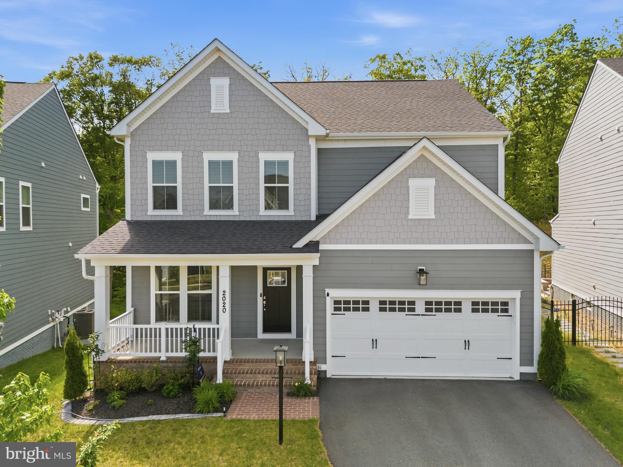 Nestled on a premium cul-de-sac lot, this stunning 2022 Pulte Mercer model offers a rare blend of privacy, serenity, and unobstructed wooded views—backing to a peaceful tree-lined setting that creates a truly tranquil retreat.

This beautifully maintained Craftsman-style single-family home features three finished levels with 10-foot ceilings and an abundance of natural light throughout. The fully finished, carpeted walk-up lower level boasts a spacious recreation room and a rough-in for a full bath, offering endless possibilities for future expansion.

The main level showcases wide luxury vinyl plank flooring, recessed lighting, and an open, flowing layout ideal for both everyday living and entertaining. Highlights include a large den/office, a stylish half bath, and a chef’s kitchen equipped with stainless steel appliances, a gas cooktop, wall-mounted chimney hood, expansive quartz countertops, a bar-height island, ample cabinetry, and a double-door pantry. The kitchen seamlessly opens to the family room, complete with a sleek electric fireplace and access to a private Trex deck—perfect for enjoying the peaceful, wooded backdrop.

Upstairs, the carpeted upper level features an expansive primary suite with a spa-inspired ensuite bath. There are three additional generously sized bedrooms on this level, the front-facing bedroom has an ensuite bath, and the two other bedrooms share a full bath with a soaking tub/shower.

Additional features include an attached 2-car garage with high ceilings and a 2-car driveway for extra parking.

Located in the highly sought-after Potomac Shores community, residents enjoy access to The Shores Club, Social Barn, fitness center, three swimming pools, multi-purpose courts, community gardens, and 9+ miles of scenic wooded trails. The community also features the only public Jack Nicklaus Signature Golf Course in Northern Virginia, along with frequent resident events and social activities. A future town center and VRE station will further enhance convenience.

Ideally situated just ¼ mile from neighborhood schools with quick access to Route 1 and I-95, this exceptional home offers the perfect combination of modern luxury, natural beauty, and vibrant community living.