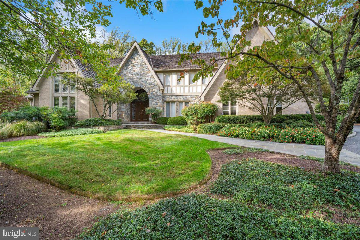 Wrapped in brick and stone and framed by a surround of trees and a glorious flowering landscape, this custom European-inspired estate is the essence of luxury living.  Masterfully designed, the main residence is perfectly positioned back from the street and features 9,665 square feet of finished living space with beautiful architectural detailing at every turn.  

Enhanced with herringbone wood flooring and custom millwork and lighting, the main level includes an elegant dining room, a great room with a stunning floor-to-ceiling stone fireplace, and a kitchen of any chef’s dreams.  A substantial island, built-ins, wine niches, both induction and gas cooktops,  and a walk-in pantry offer every essential for day-to-day living or entertaining.  Completely renovated by BOWA, the kitchen adjoins an octagonal casual dining space capped with a vaulted ceiling and overlooking the grounds.  Appointed with a custom ceiling, a full bath and accented by a wall of windows, the home office offers privacy and flexibility as either a work space or another bedroom.  Offering an amenity that can be challenging to find, the primary suite is also on the main level, and includes a spacious bedroom, a delightful sitting room, his-and-hers baths reinvented and dual walk-in closets.  Multiple rooms on the main level open to terraces and decks, blurring the distinction between indoors and outdoors.  

The same level of attention to detail is upstairs, where there are three expansive bedrooms, all with walk-in closets.  Enhanced by built-ins and designer finishes, each bedroom has a personality of its own. One of the gracious bedrooms is ensuite, and the other two connect with a large Jack-and-Jill bath.  

Truly an entertainer’s dream, the finished lower level offers every amenity for leisure. There are game rooms, a mirrored exercise room, and an expansive recreation room with a beautiful custom bar and stately fireplace.  With every option for the household or guests, a spacious bedroom and full bath complete the lower level floorplan.  Whether it’s a quiet family night, a Superbowl party or the place to wind down after an afternoon in the pool, the luxurious lower level of this home is one for every season. 

Step outside to the breathtaking, resort-style backyard, where multiple terraces lead to a heated pool and 280-square foot cabana. In authentic cabana style, this one opens via roll-up doors and has seating space for 8, an air-conditioned bathroom, a gas grill and 2 under-counter refrigerators. This structure also houses the pool bathroom and a separate room for the pool equipment. 

Surrounded by towering trees and enhanced by professional exterior lighting, the outdoor living and recreation spaces offer a magical setting and the ultimate privacy. From the heated three car side-loading garage to the ample storage space found on every floor, this residence elevates the concept of form and function to a new level.  Every detail has been considered, with recent improvements including a whole house generator, new garage door and driveway.  For the buyer seeking turn-key luxury living indoors and out, this residence checks every box! 

Public record reflects total square footage of 11,005. 
Floorplan by Floor Plan Visuals reflects total square footage of 11,940 (finished 9,665).
All measurements are approximate. Property details and square footage should be independently verified, and not used for property valuation.