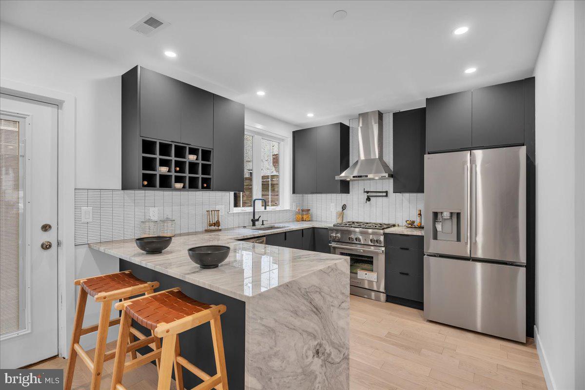 A refined expression of modern city living, 1146 N Galloway Street introduces a newly completed residence in the heart of Northern Liberties, offering approximately 2,550 sq. ft. of thoughtfully designed living space, including a fully finished basement and  convenience of 1-car parking spot in front of the home.

Designed with intention, this 5-bedroom, 3 full and 1 half bath home blends clean architectural lines with warm, natural materials. Wide-plank white oak flooring flows throughout, creating a timeless and inviting foundation.

At the center, a striking kitchen anchors the main level, featuring Thermador and LG appliances, a marble waterfall island and countertops, and sleek contemporary cabinetry. Just beyond, a convenient backyard extends the living space outdoors, ideal for dining, entertaining, or everyday ease.

Living spaces unfold across multiple levels, with generously sized bedrooms and well-appointed baths on the second and fourth floors, along with a dedicated laundry area. The entire third floor is devoted to a light-filled primary suite, offering a spa-inspired bath with a double vanity, soaking tub, and a spacious walk-in closet.

At the rooftop level, a thoughtfully designed wet bar enhances the experience, complete with a sink, countertop, custom cabinetry, and a double-door beverage refrigerator, perfectly positioned for seamless indoor-outdoor entertaining. Just beyond, the private rooftop deck captures sweeping skyline views, creating an elevated setting for gatherings or quiet moments above the city.

Additional features include dual-zone HVAC, a full 10-year tax abatement, and a 1-year builder warranty.

Set on a quiet residential block just moments from the energy of Northern Liberties, known for its cafés, fitness studios, dining, and everyday conveniences, this home offers a rare blend of space, design, and location in one of Philadelphia’s most sought-after neighborhoods.